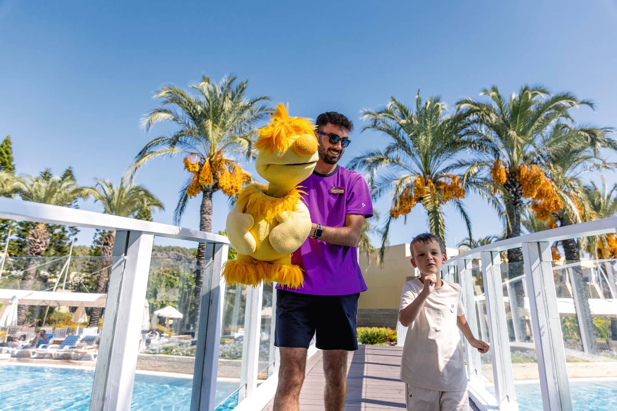 A kids' entertainer holding a puppet mascot.