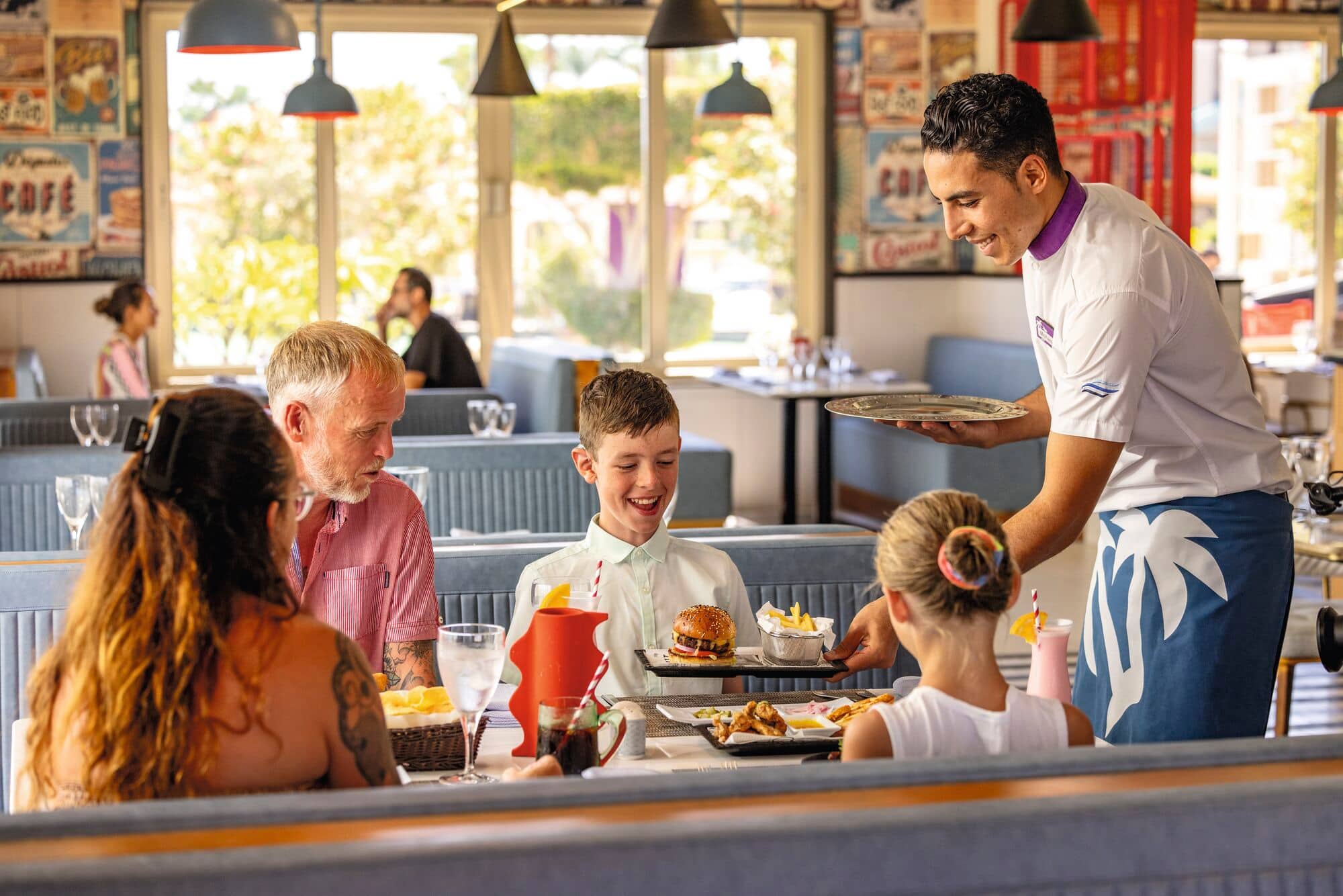 A family enjoying a meal at a restaurant.