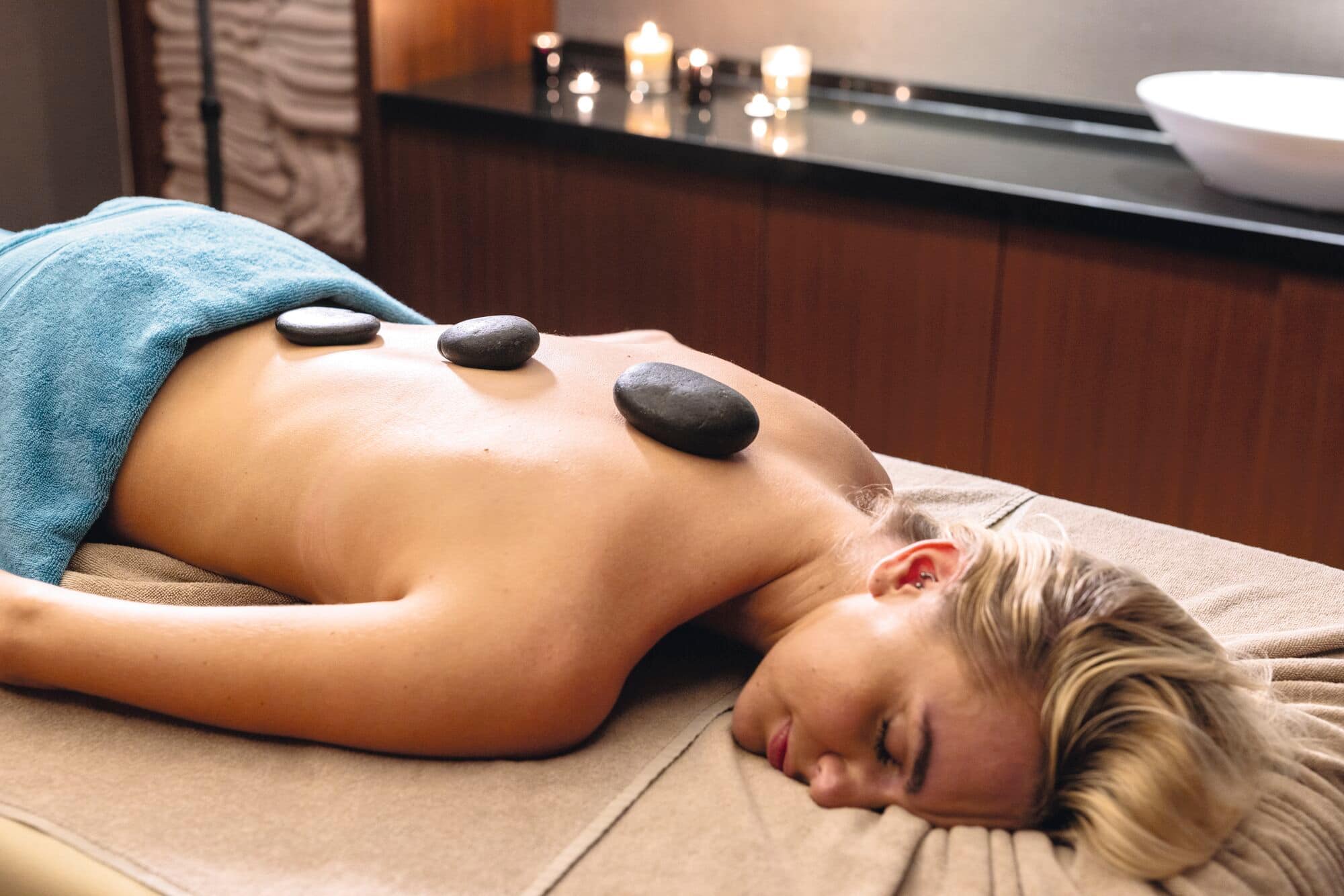 Woman having a hot stone massage.