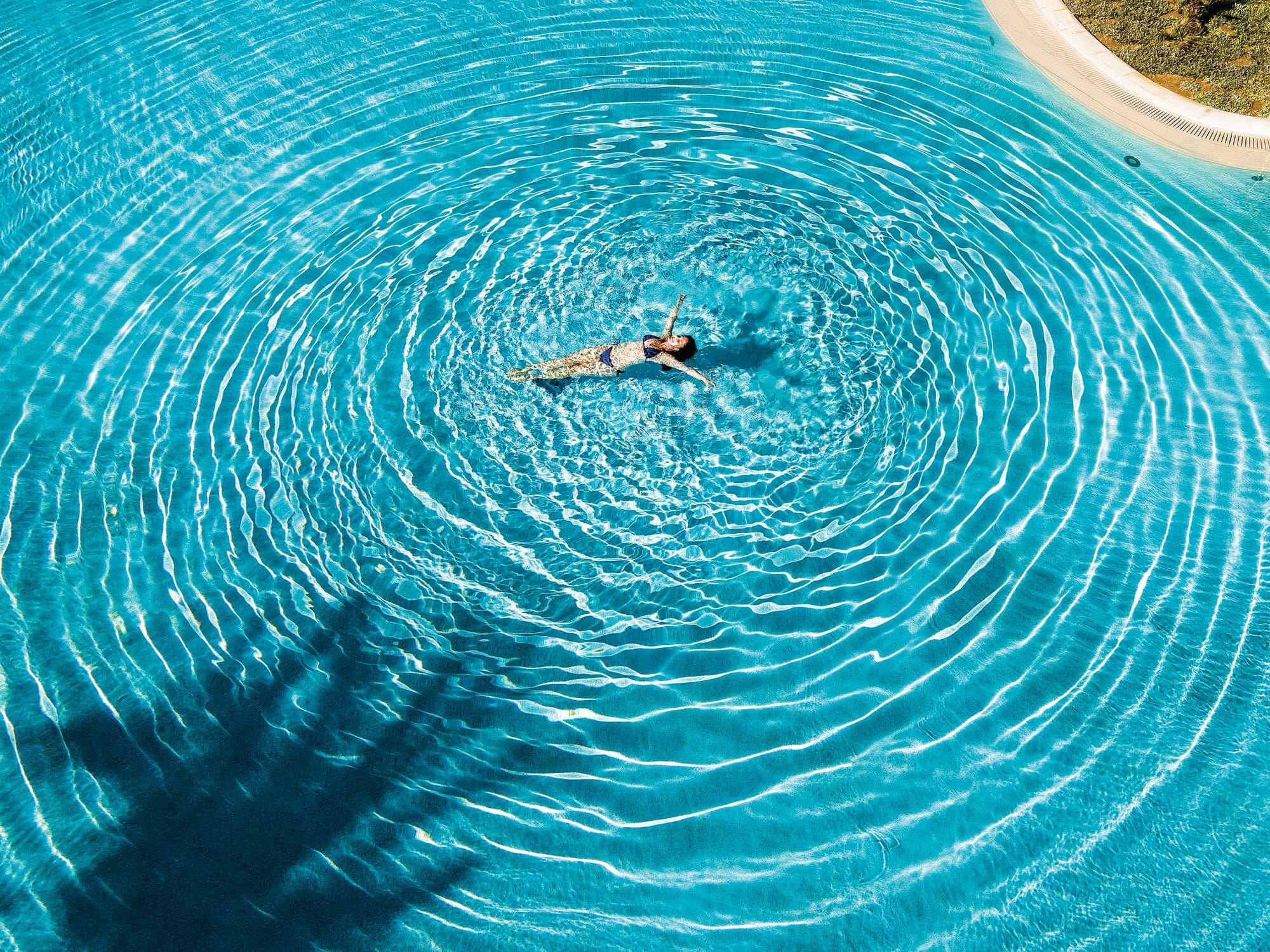 Woman floating in a swimming pool.