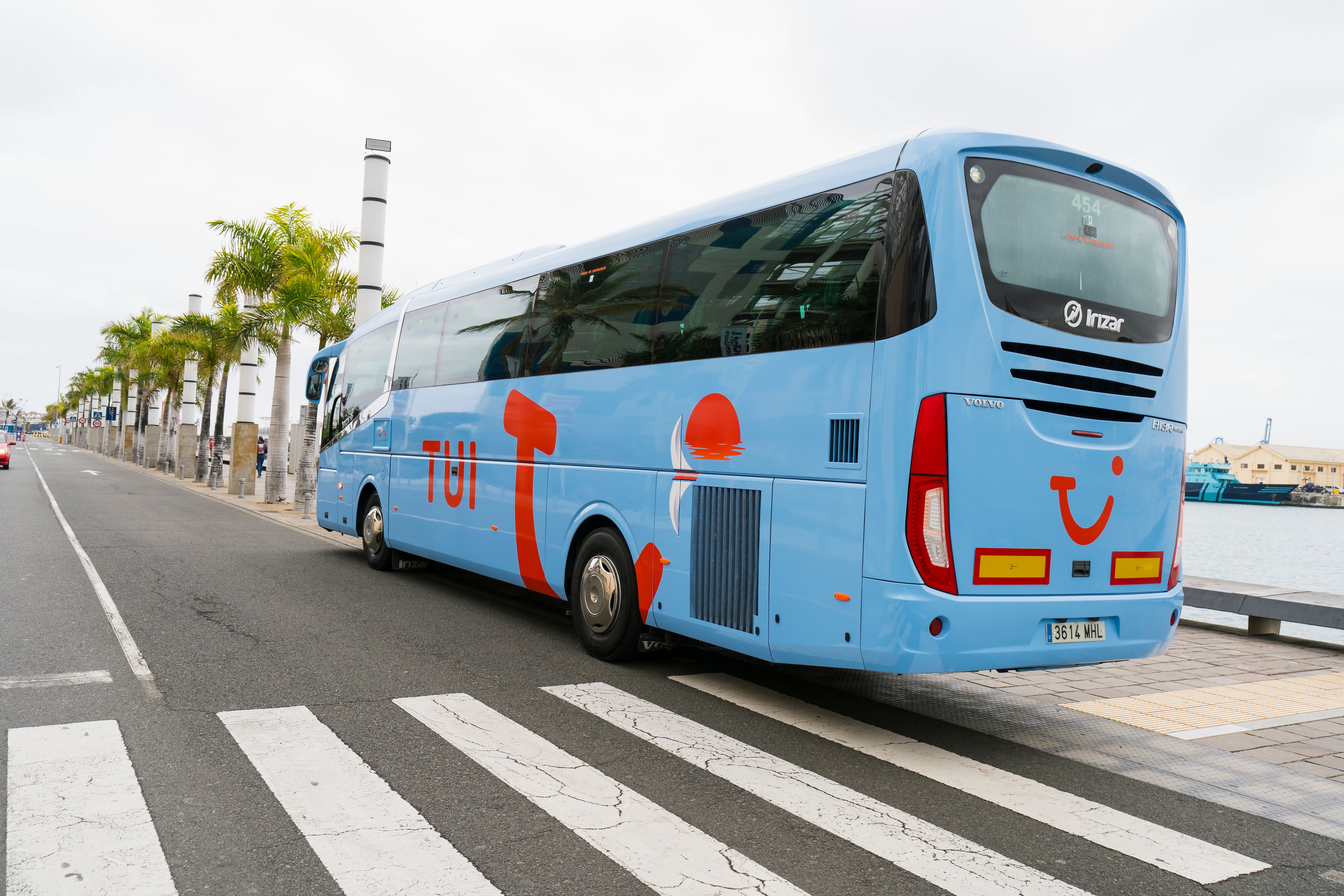 A blue TUI coach waits at the roadside.