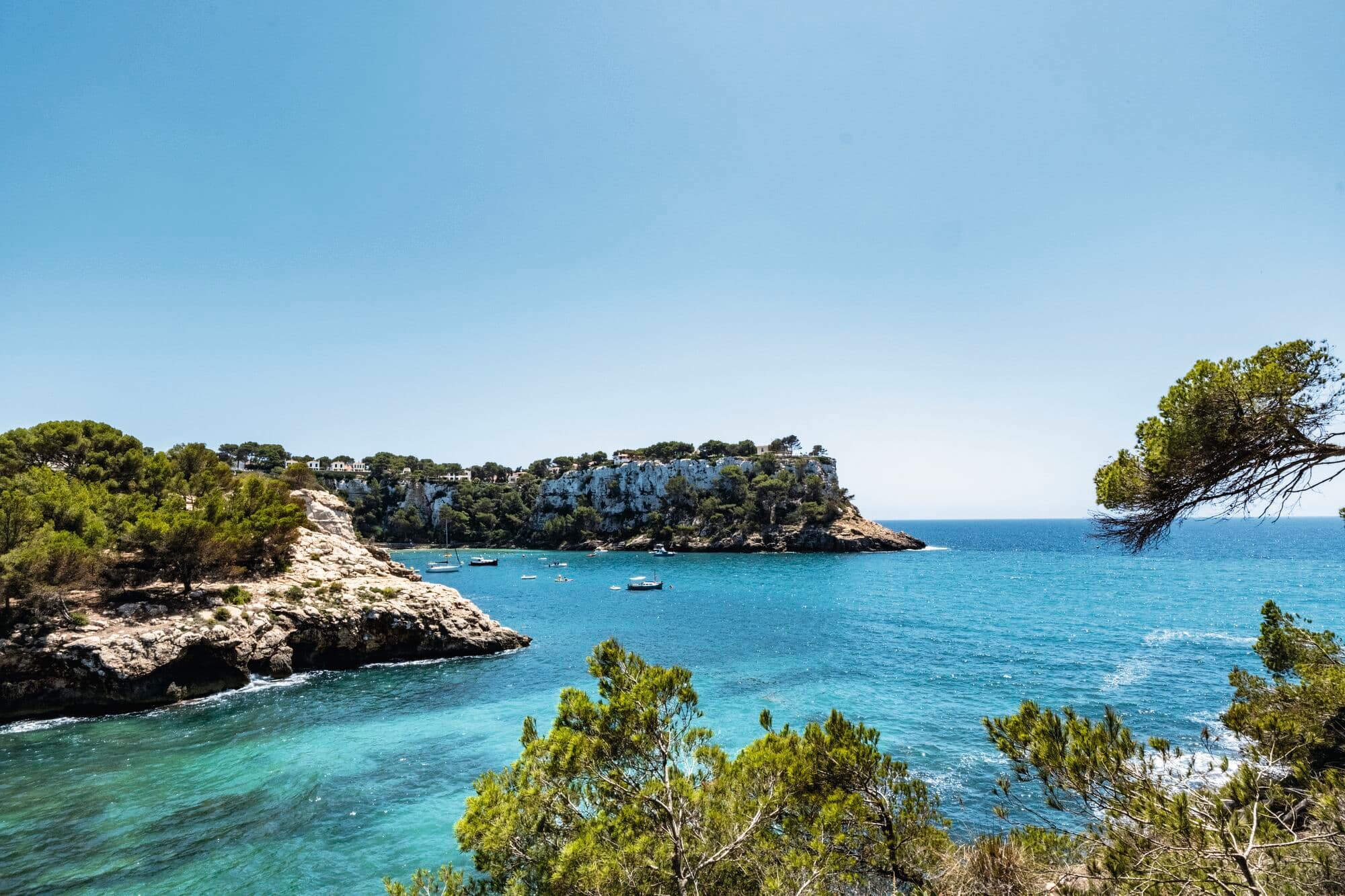A view of the Galdana coastline, with rocky outcrops and clear-blue sea..
