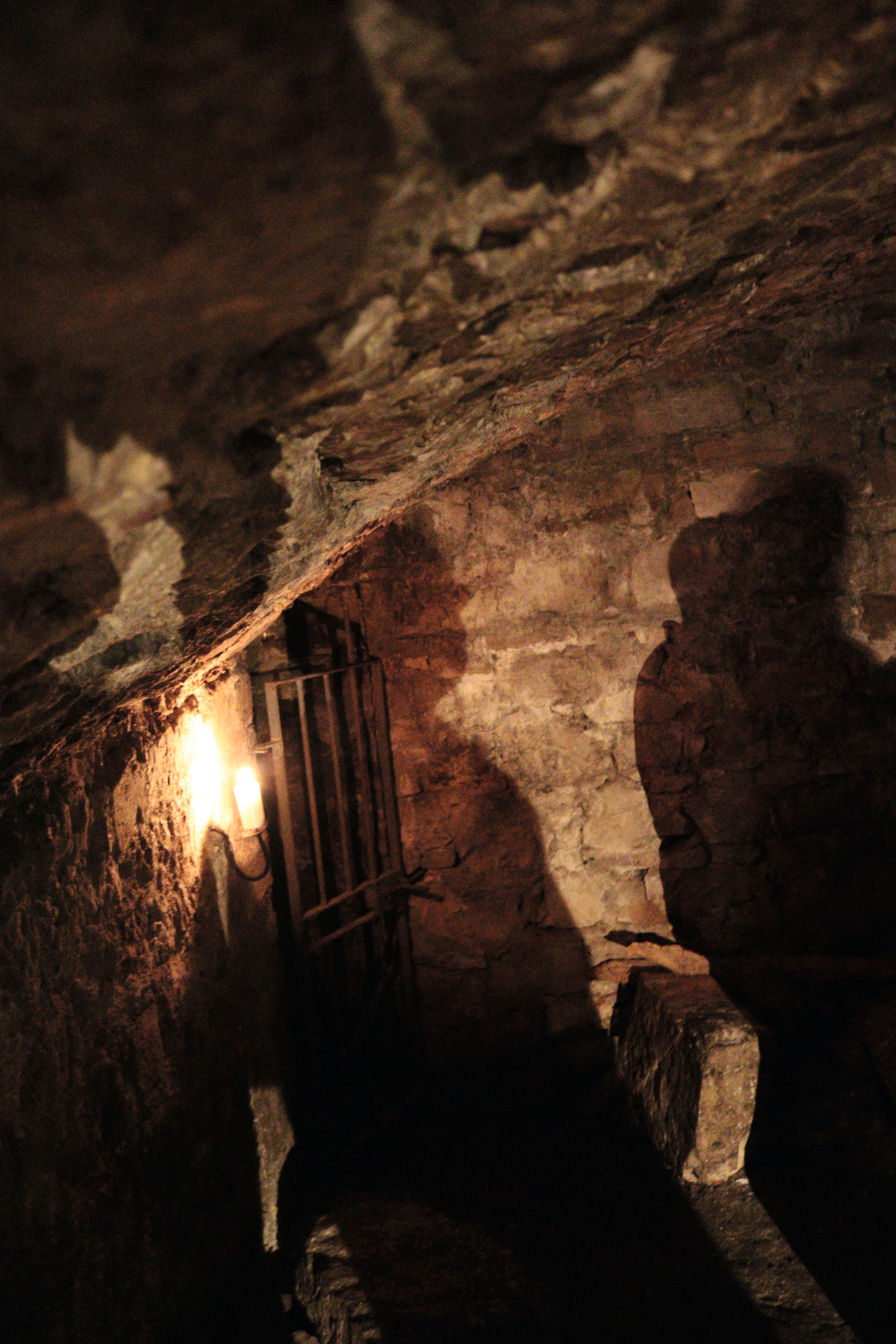 A dark tunnel illuminated by lantern.