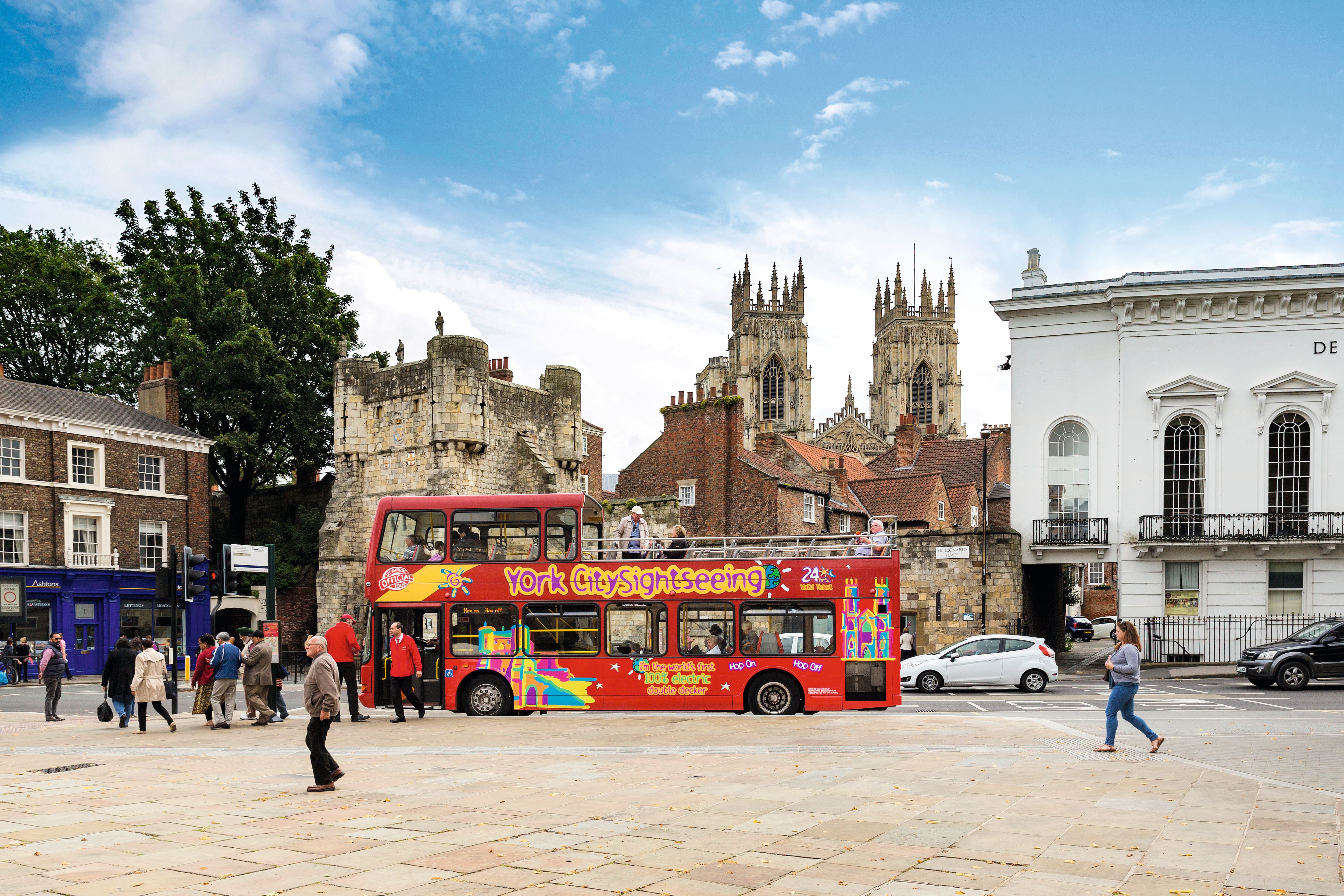 24-hour hop-on-hop-off city sightseeing bus travelling through York.