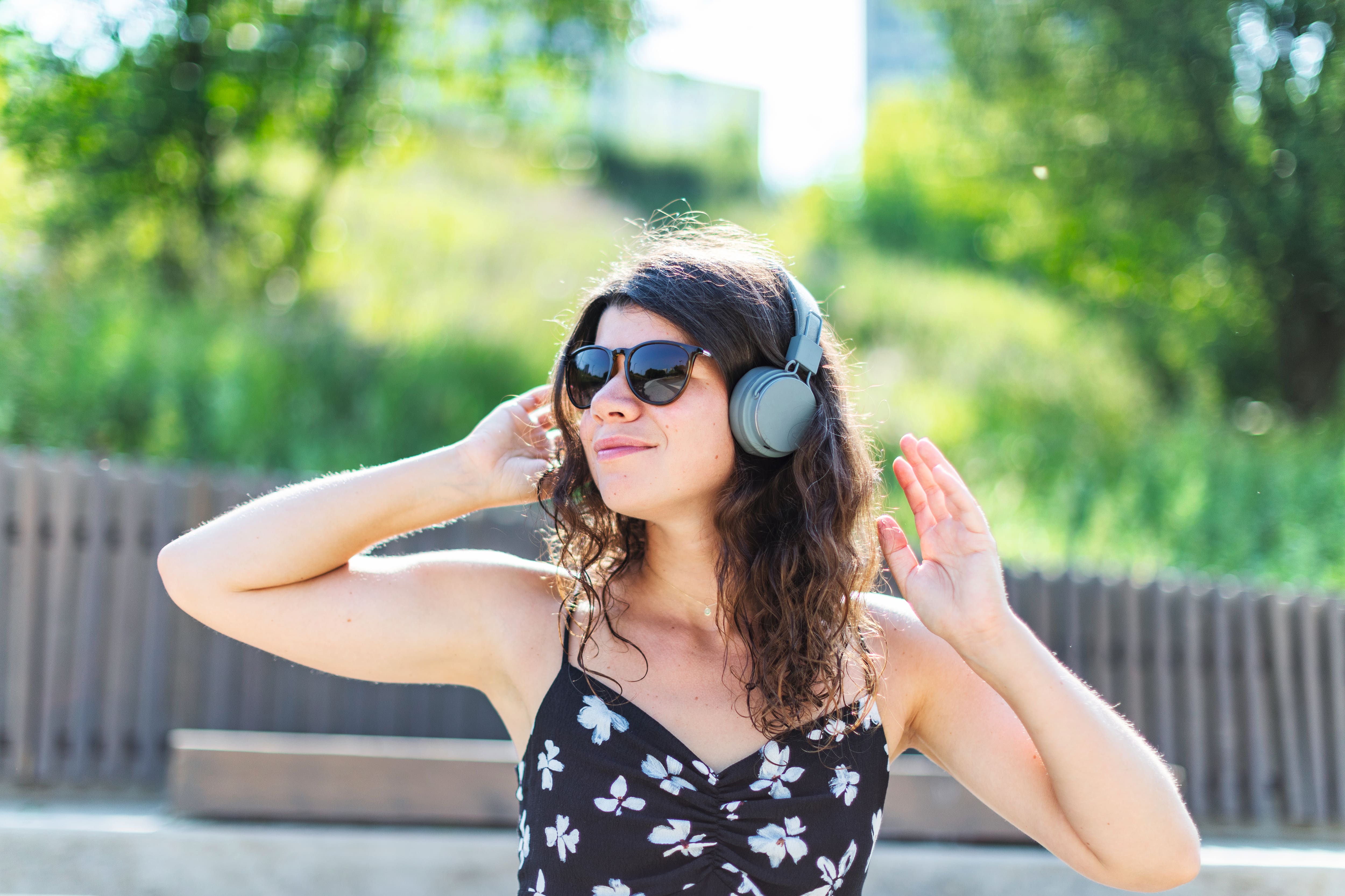 young woman listening to music in headphones.