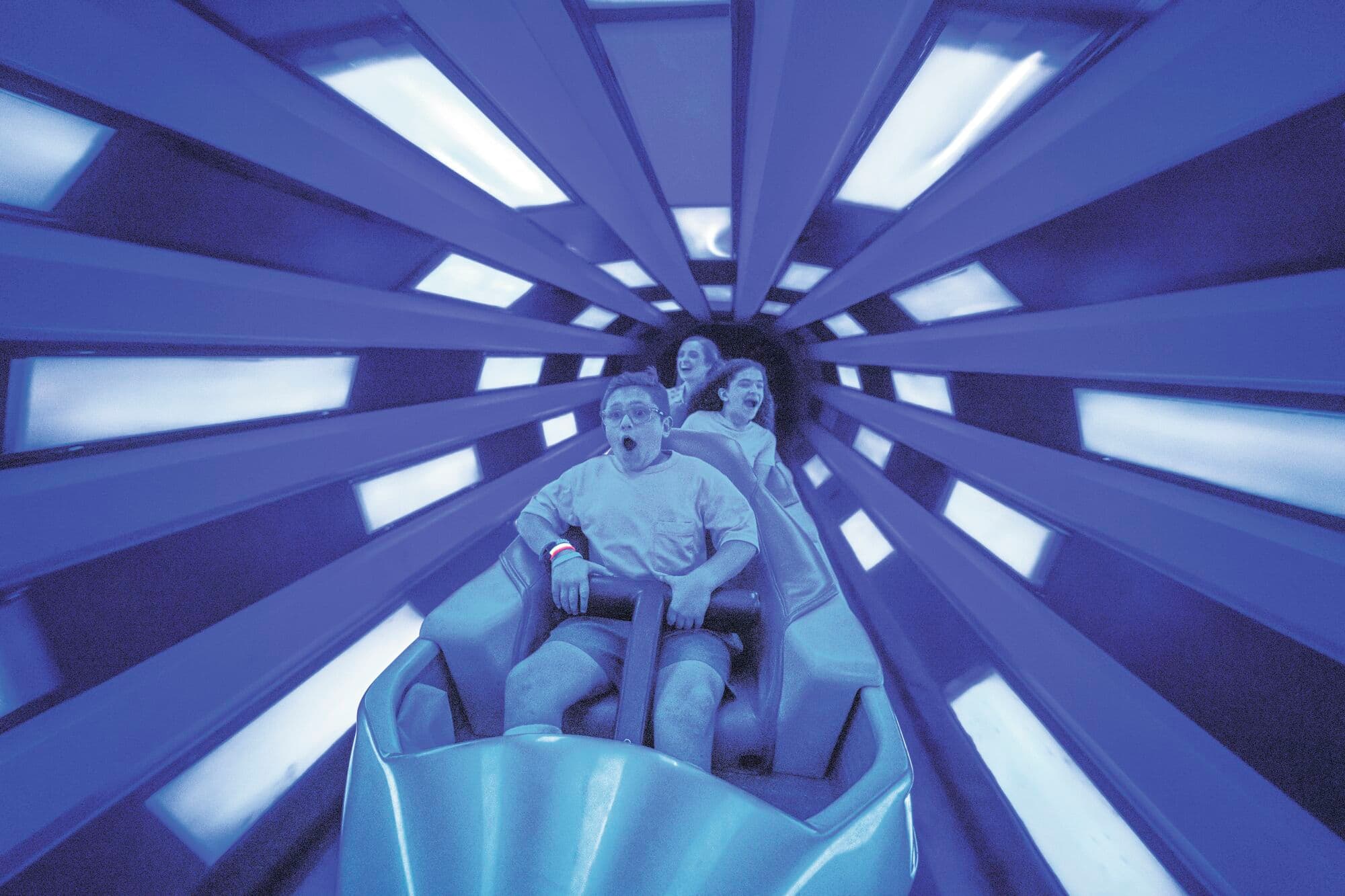Children enjoying a ride in Tomorrowland.