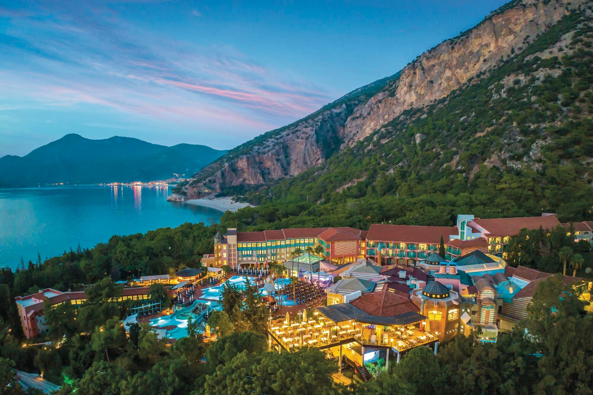 Aerial view of Liberty Hotels Lykia Adults Only and the surrounding sea and mountains.