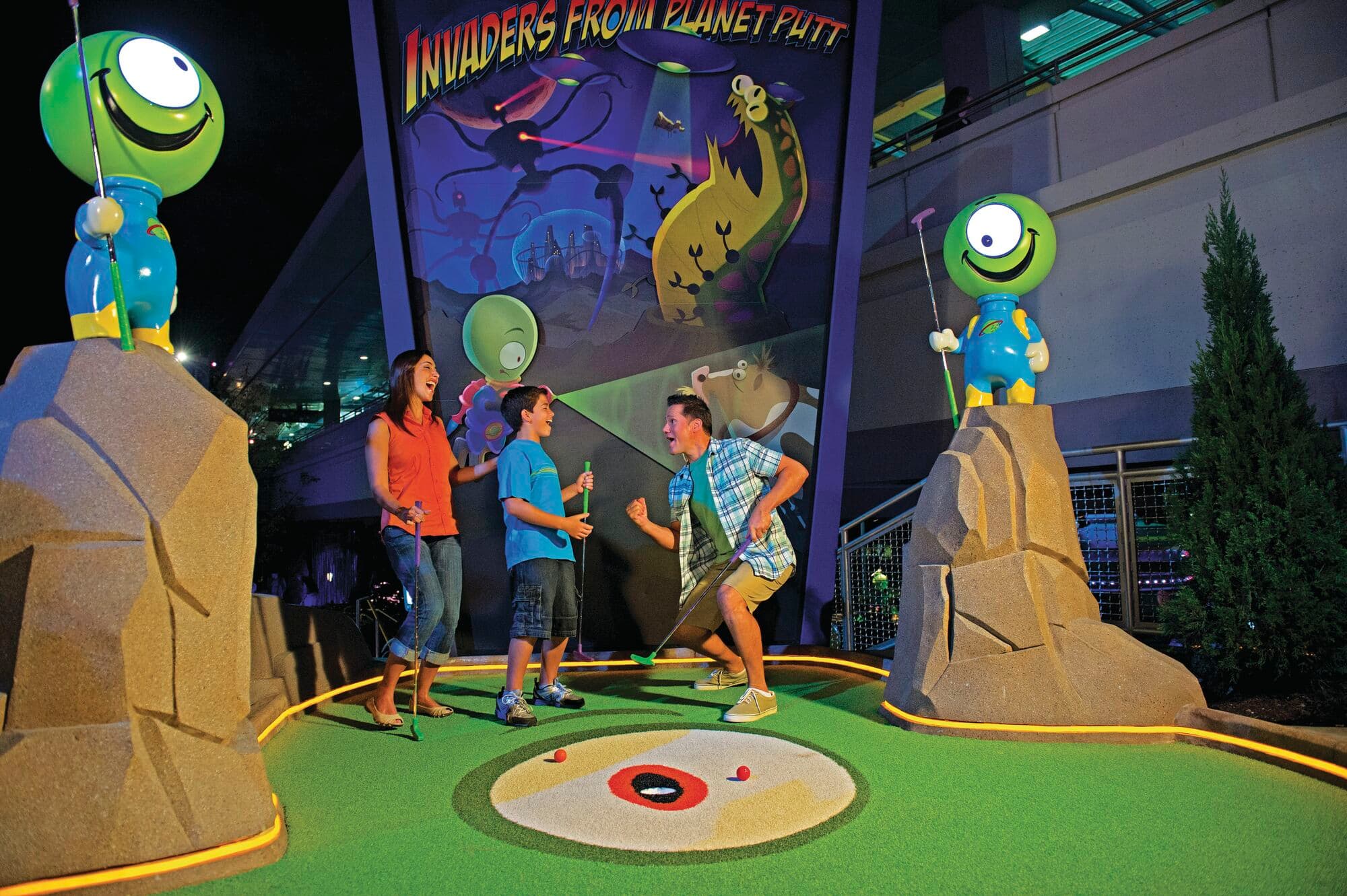 A family playing crazy golf.