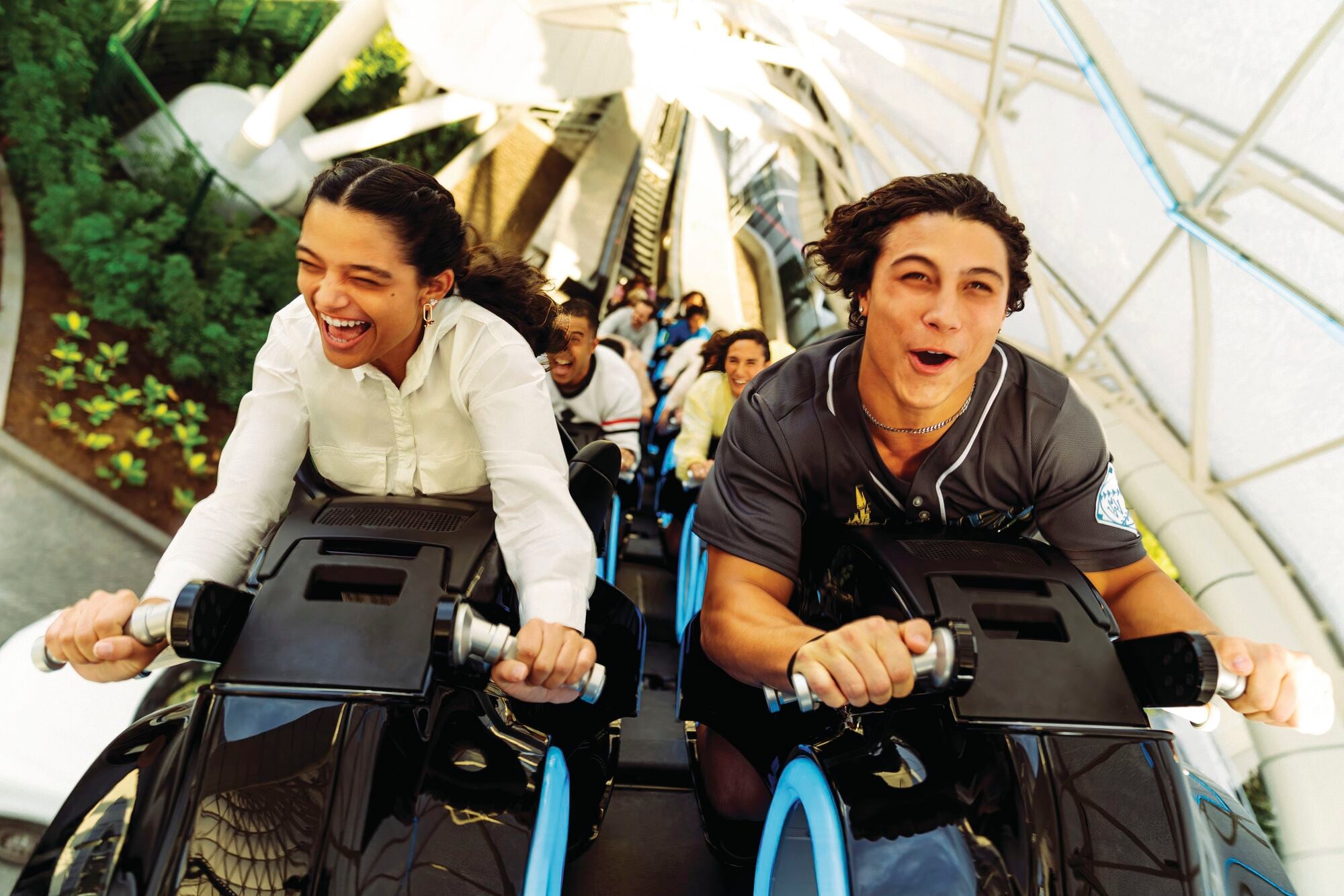 Two people enjoying the Tron Lightcycle ride.
