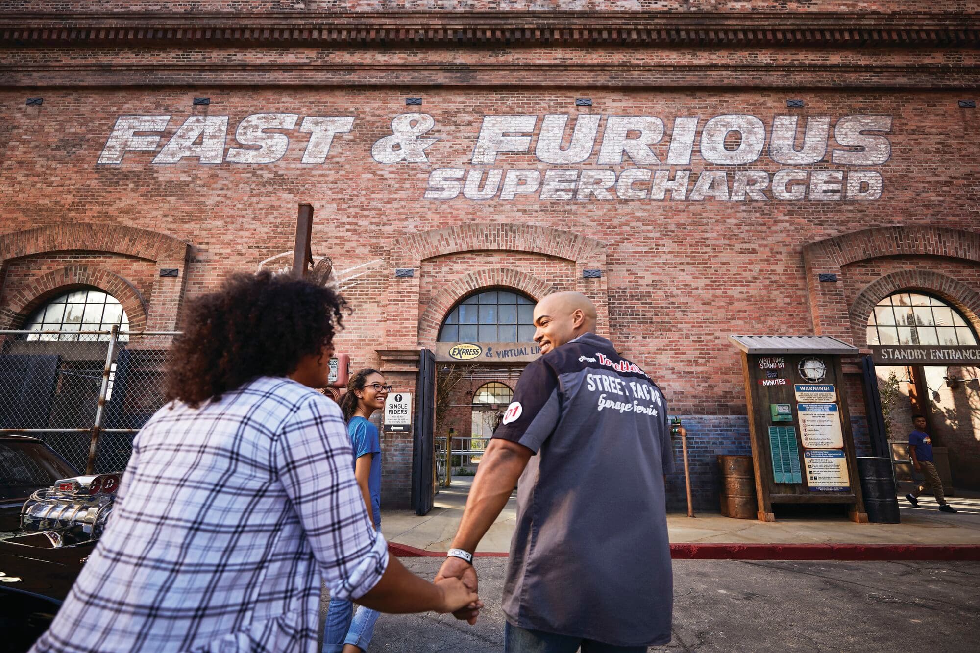 A family approaches the Fast & Furious: Supercharged entrance at Universal Studios Florida.
