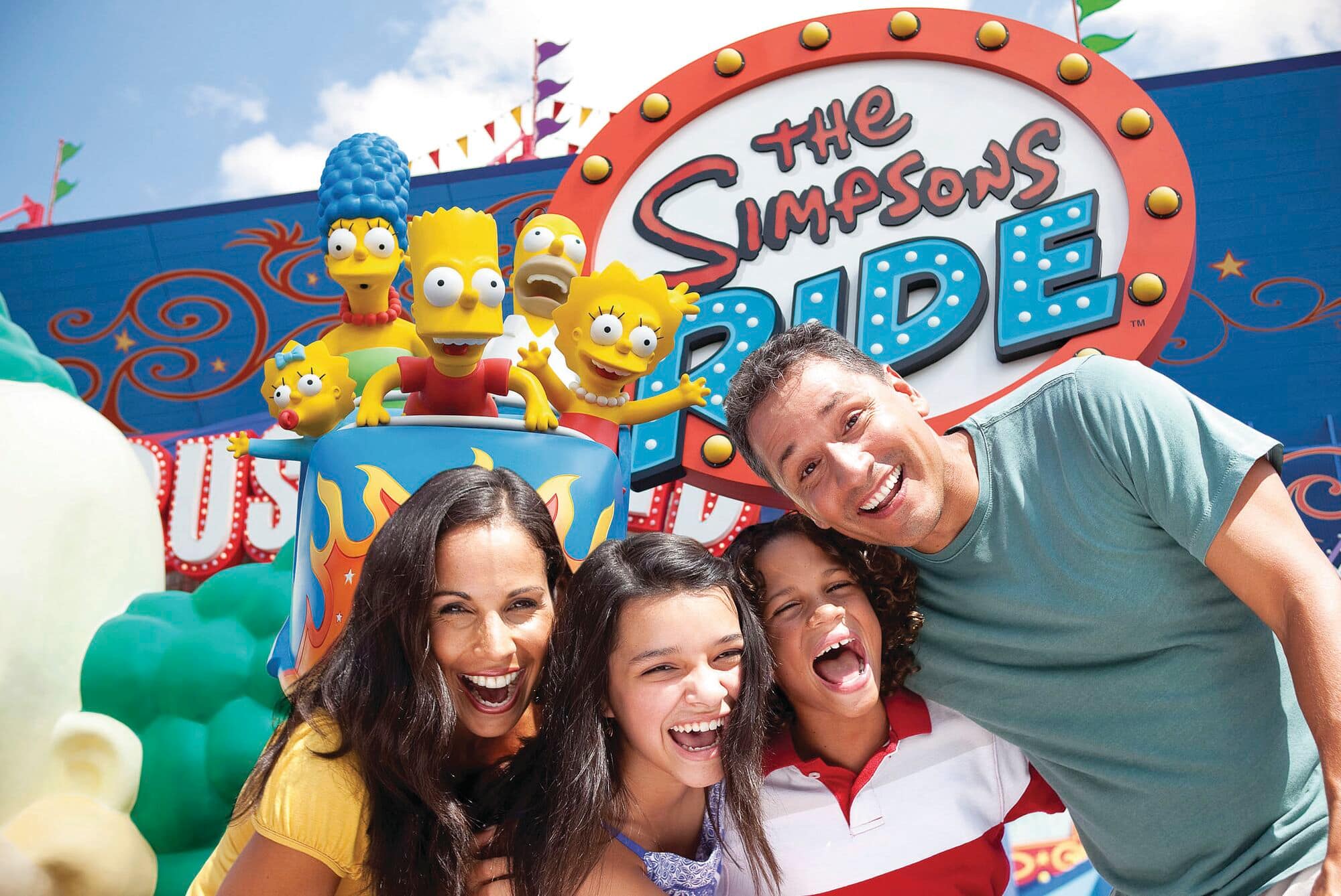 Family members smile at the entrance to The Simpsons Ride at Universal Studios Florida. 