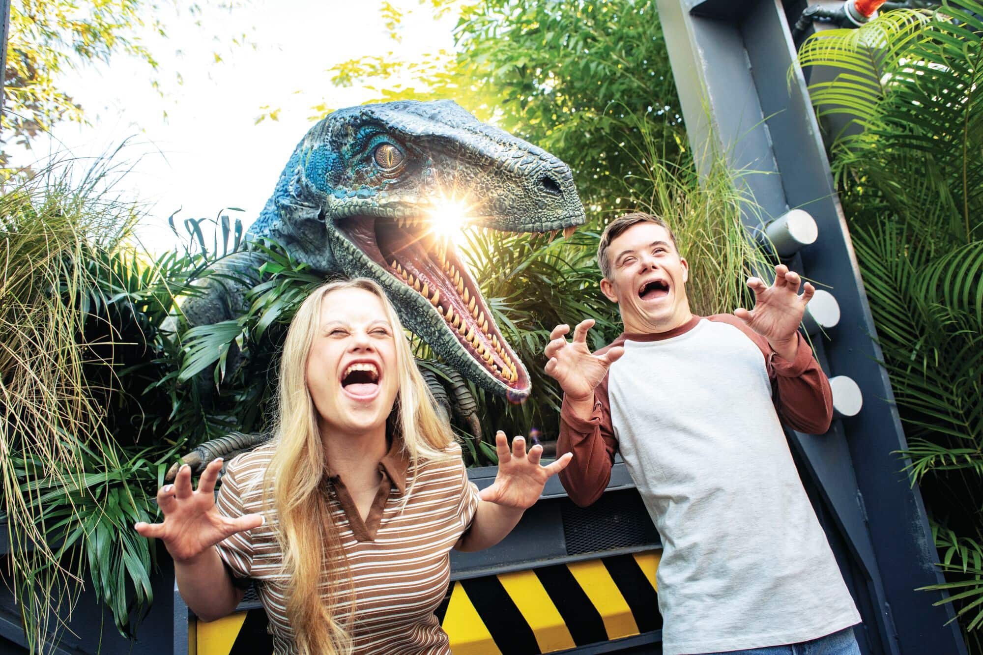 Velociraptor bursts through jungle gate – lush greenery, warning signs and a thrill of danger.