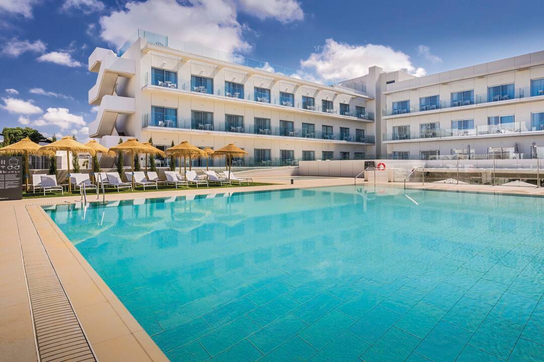The main pool area with sunloungers and parasols