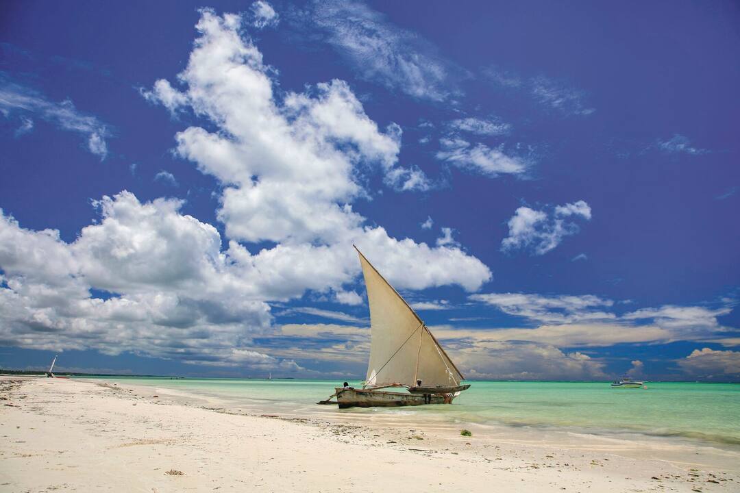 A dinghy sits on Pwani Mchangan beach