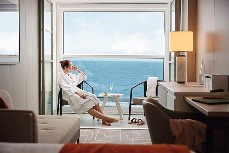 A customer relaxing on her cabin balcony.