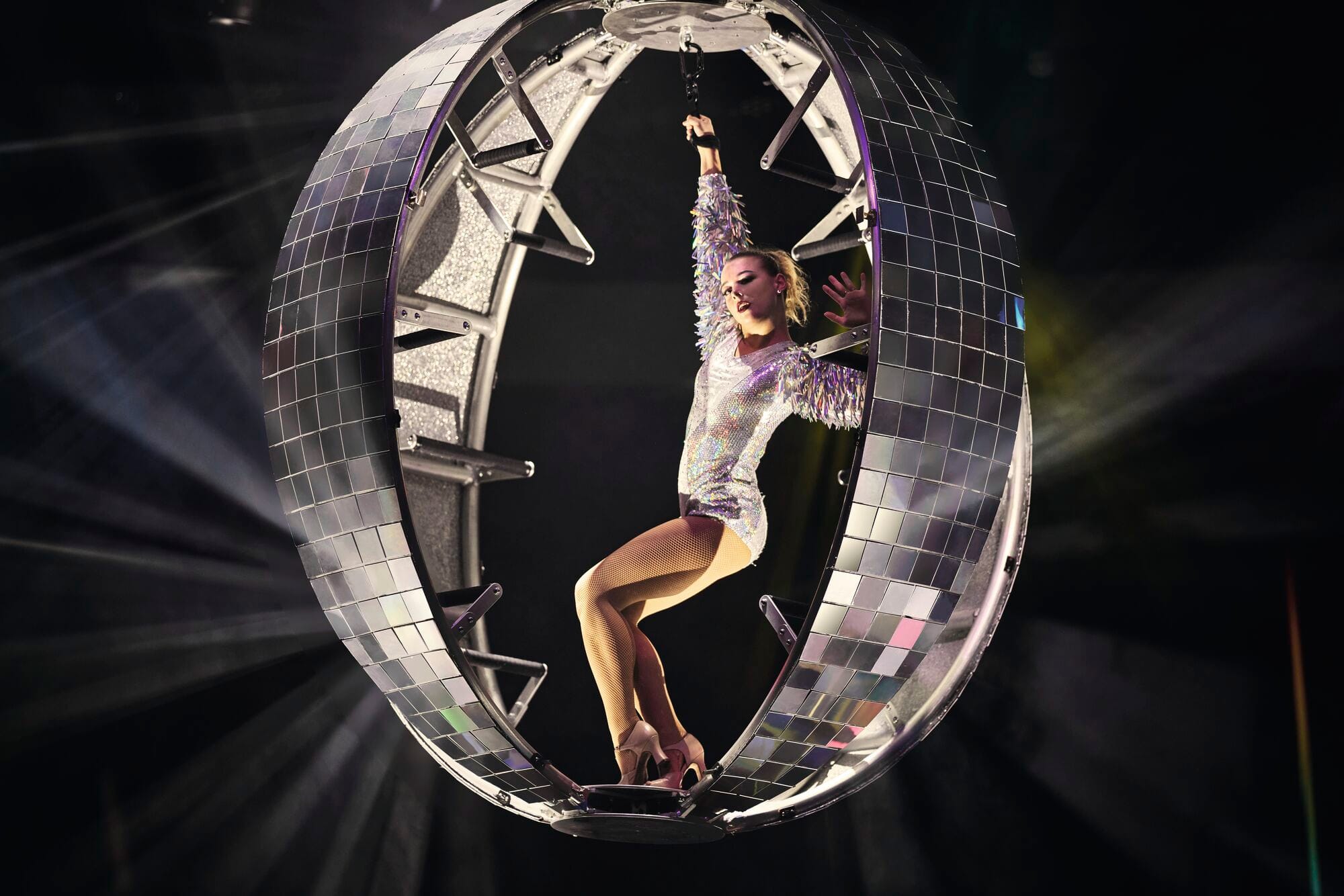 A performer dancing in a giant disco ball.