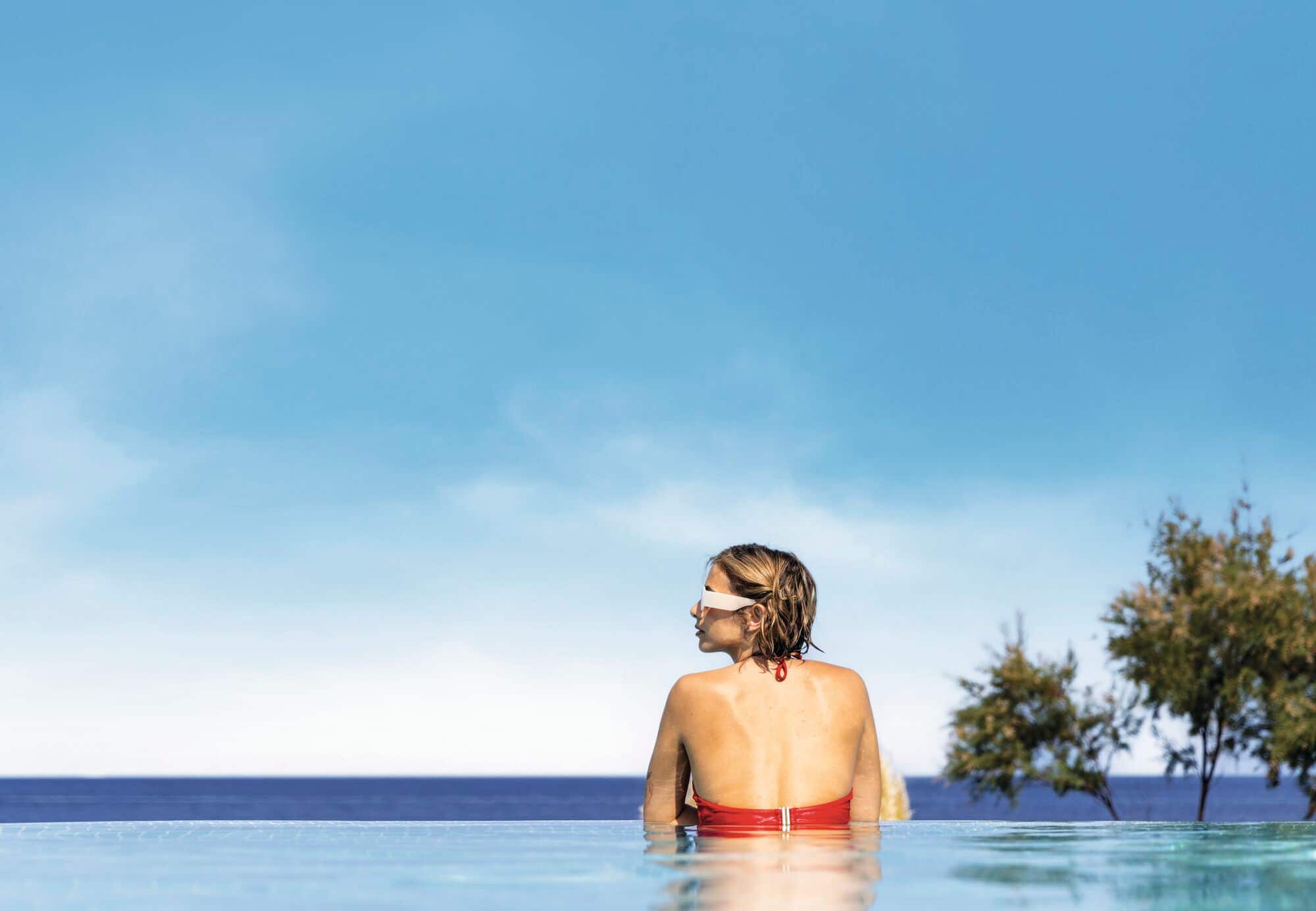Woman in a swimming pool looking out.