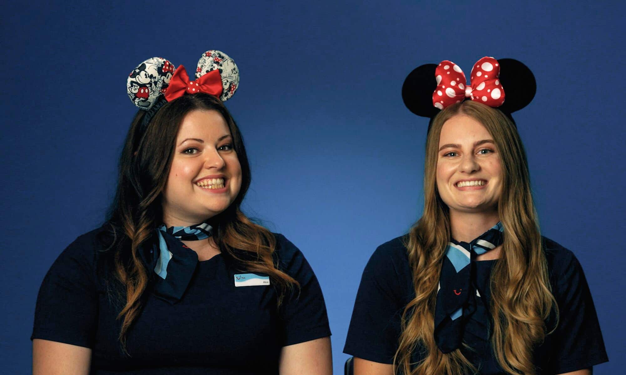 Two TUI Disney Experts wearing colourful Mickey ears.