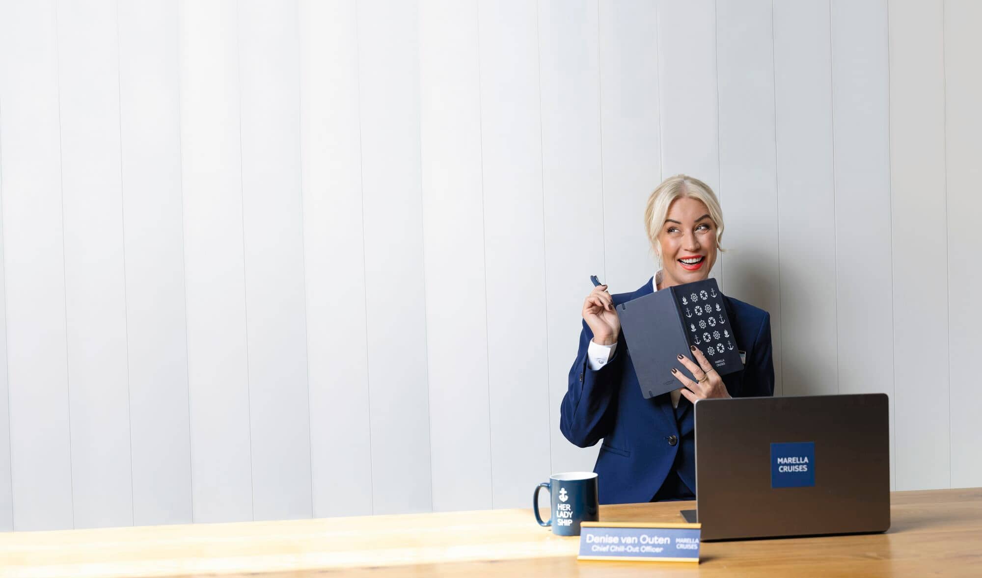 Denise Van Outen at desk with notebook and pen in her hand 