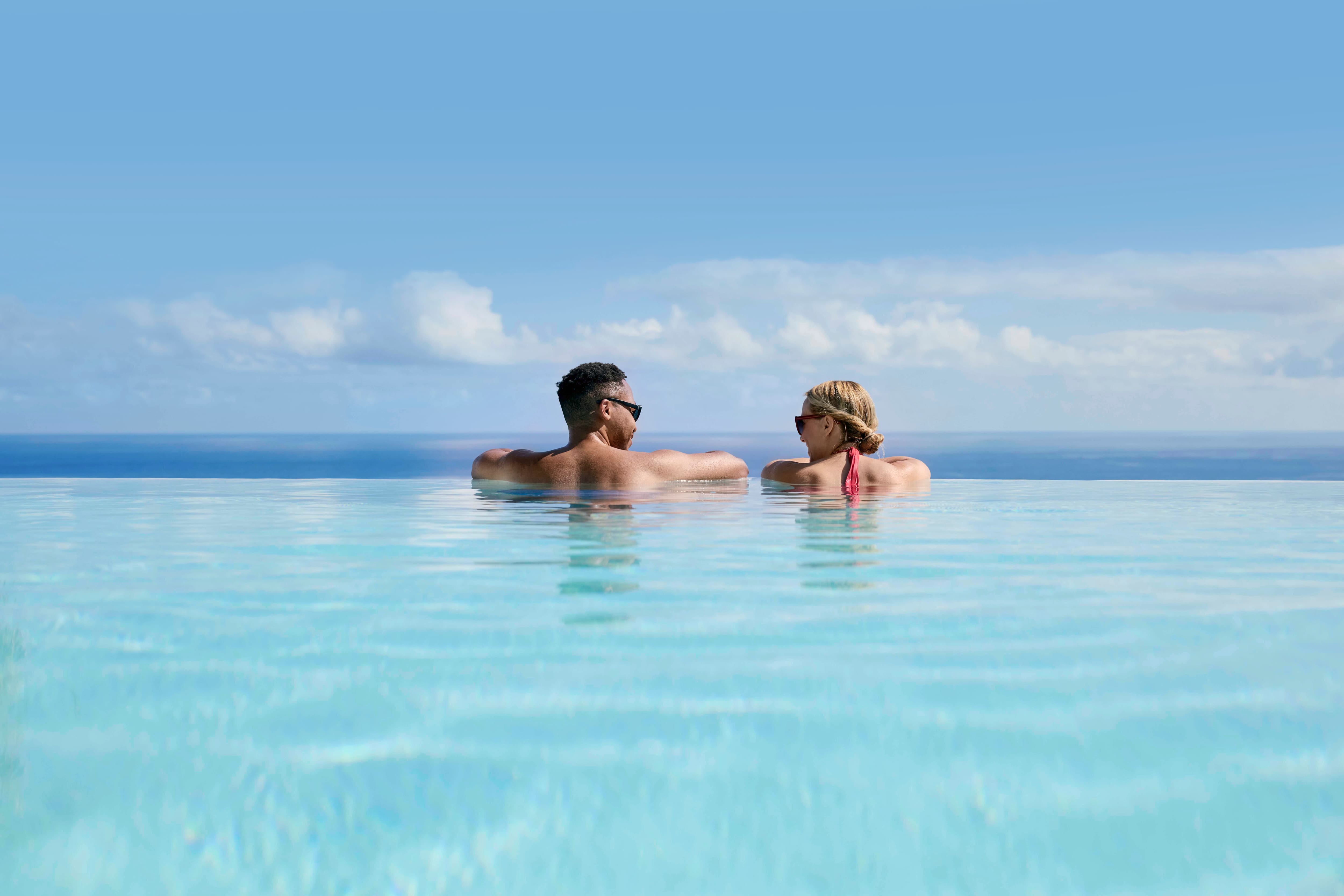 A couple on the edge of an infinity pool.