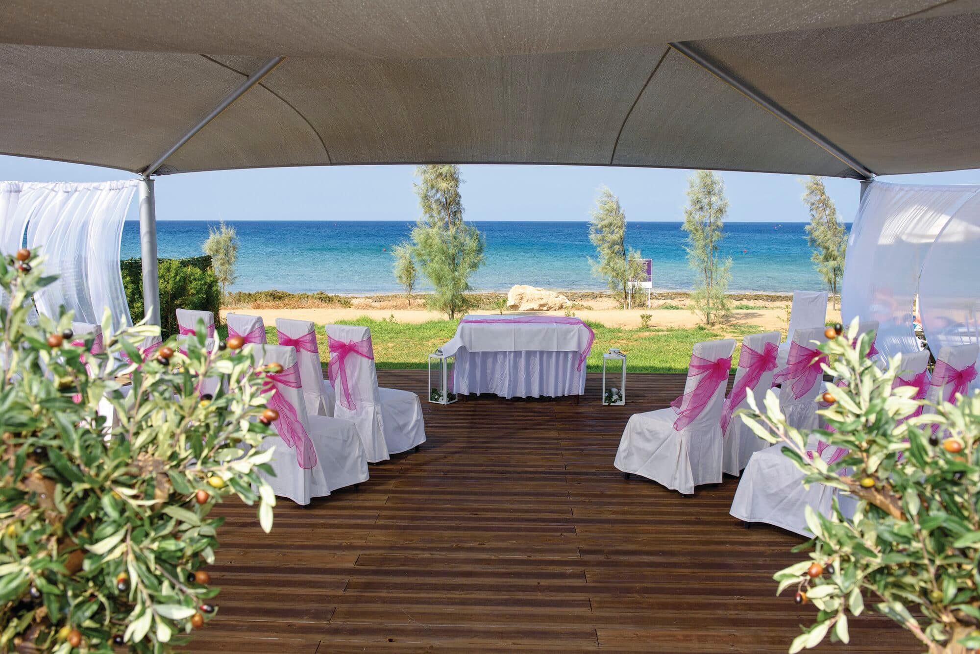 A wedding ceremony set up on the beach.