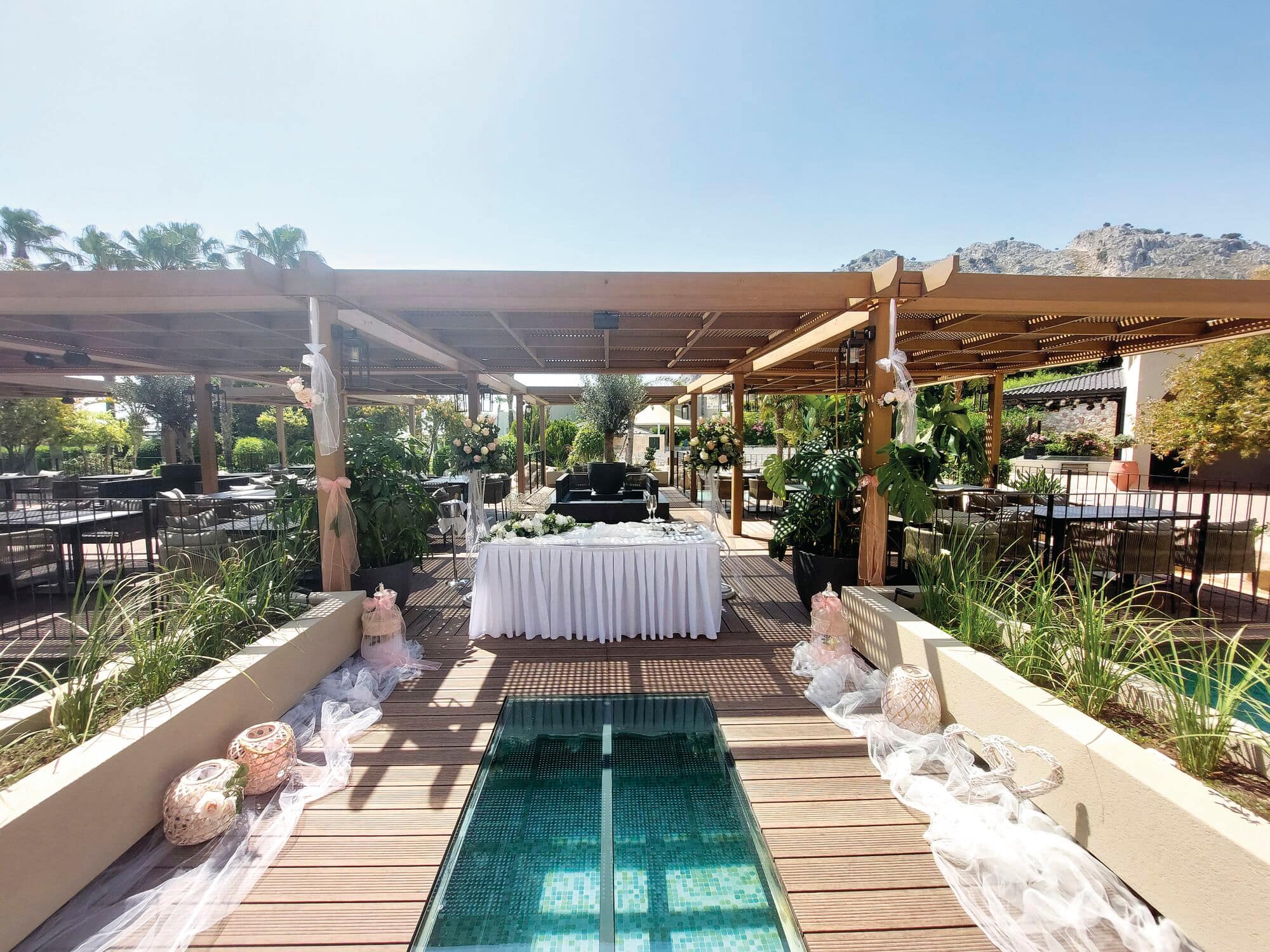 A wedding reception set-up held under a wooden outdoor terrace.