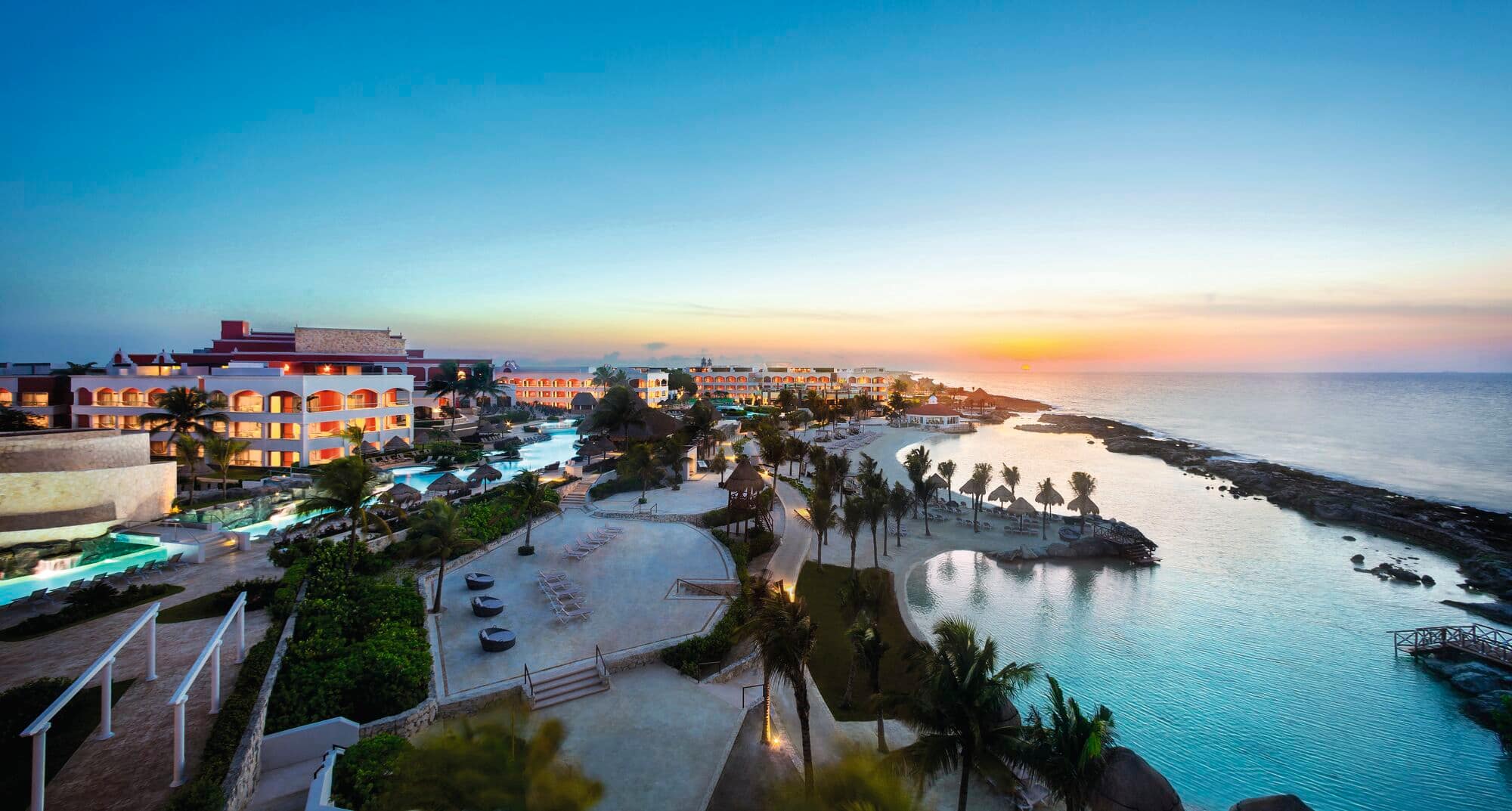 Overhead view of a seafront resort at sunset.