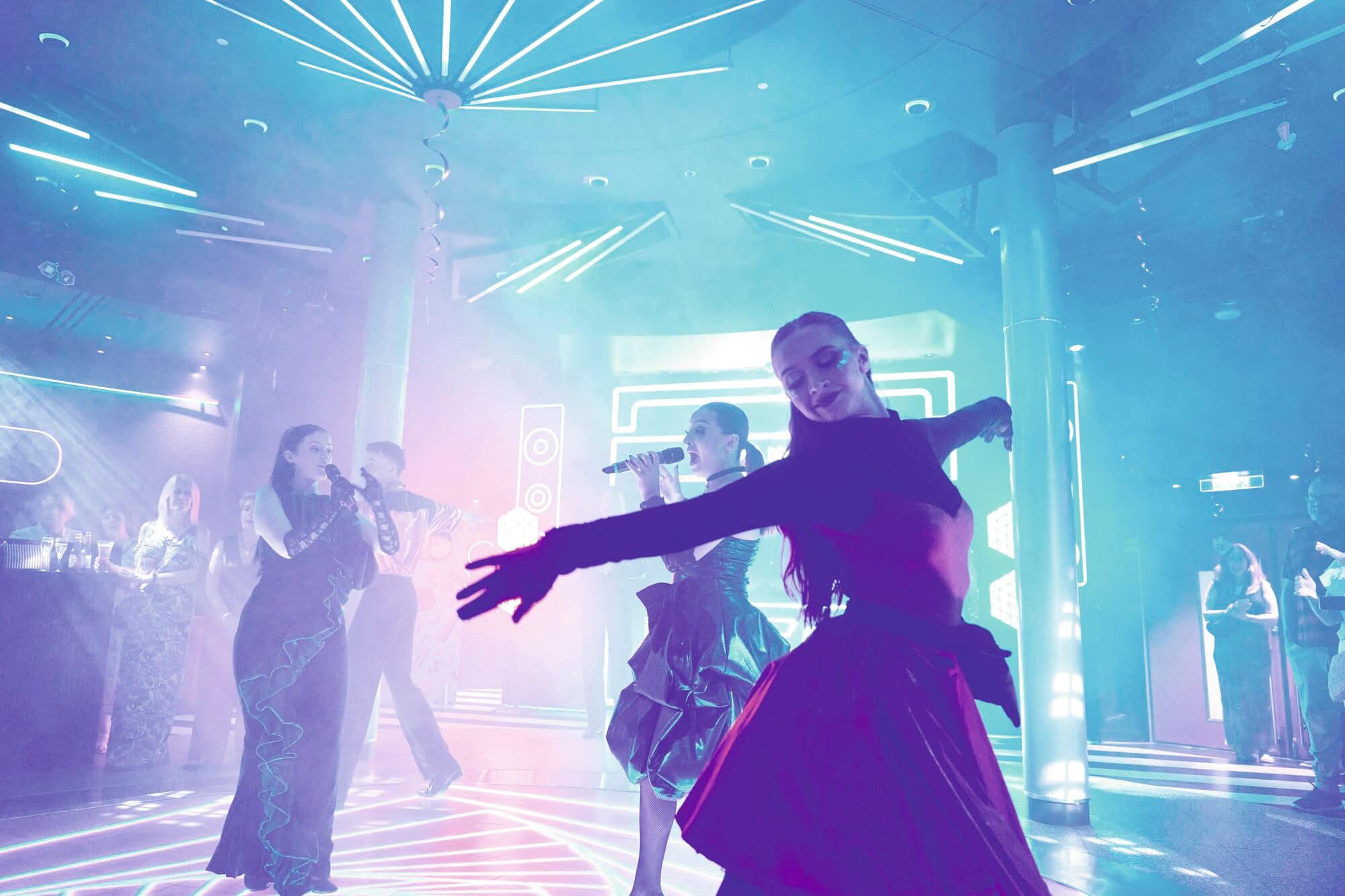 Singers performing in front of a crowd