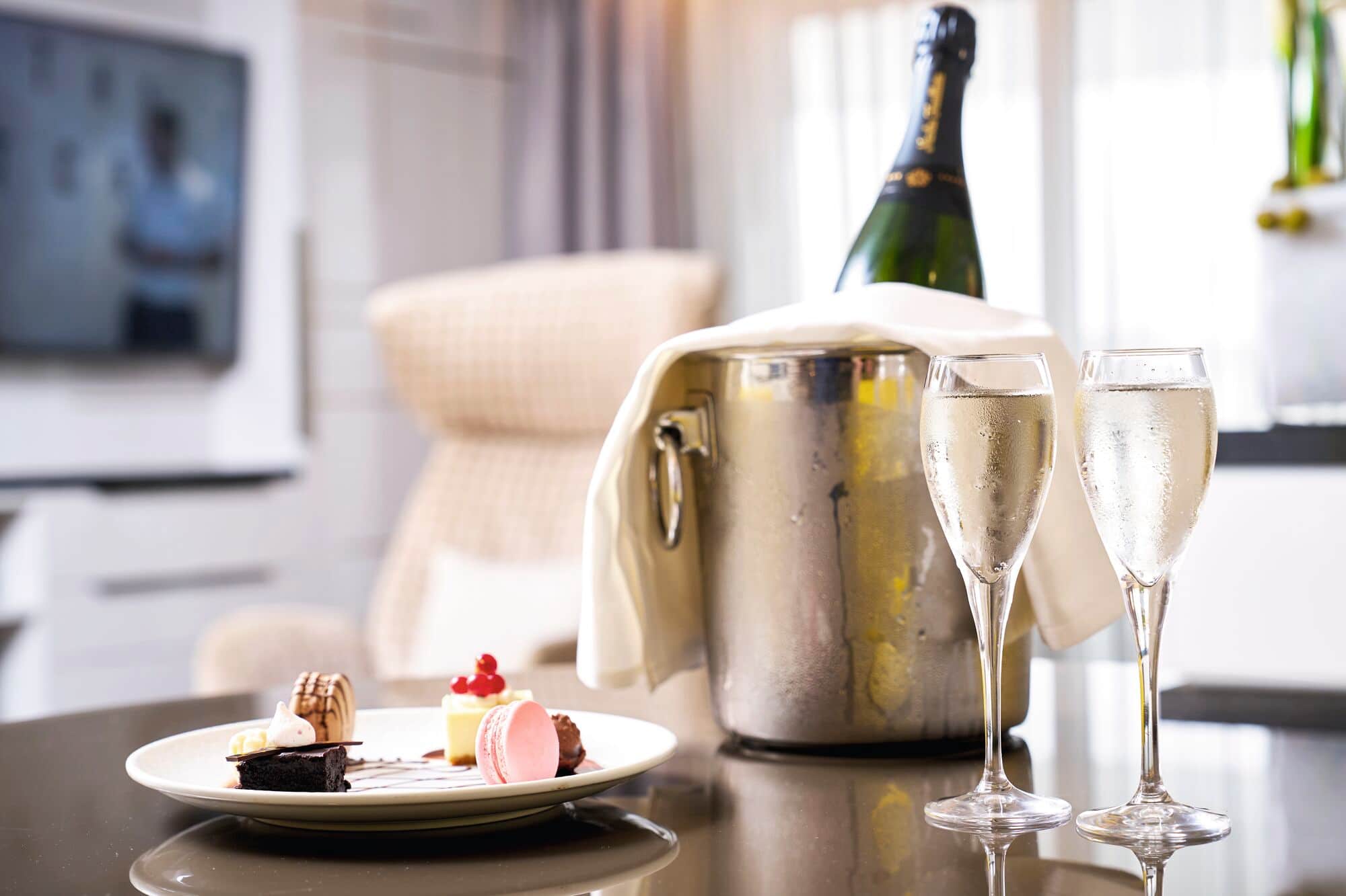 A bottle of Champagne on a table in a cabin.