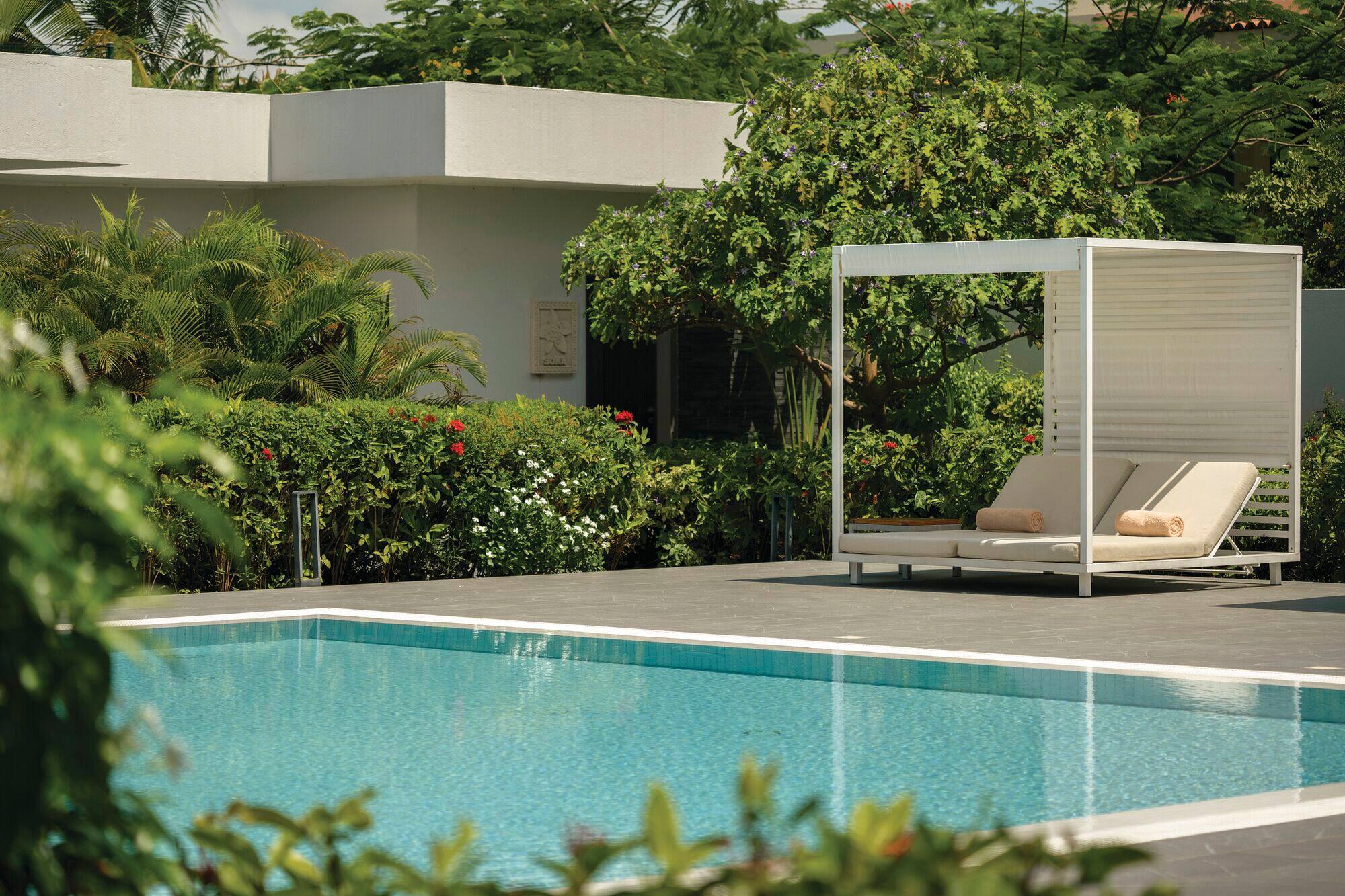 A view of sunloungers beside a pool.