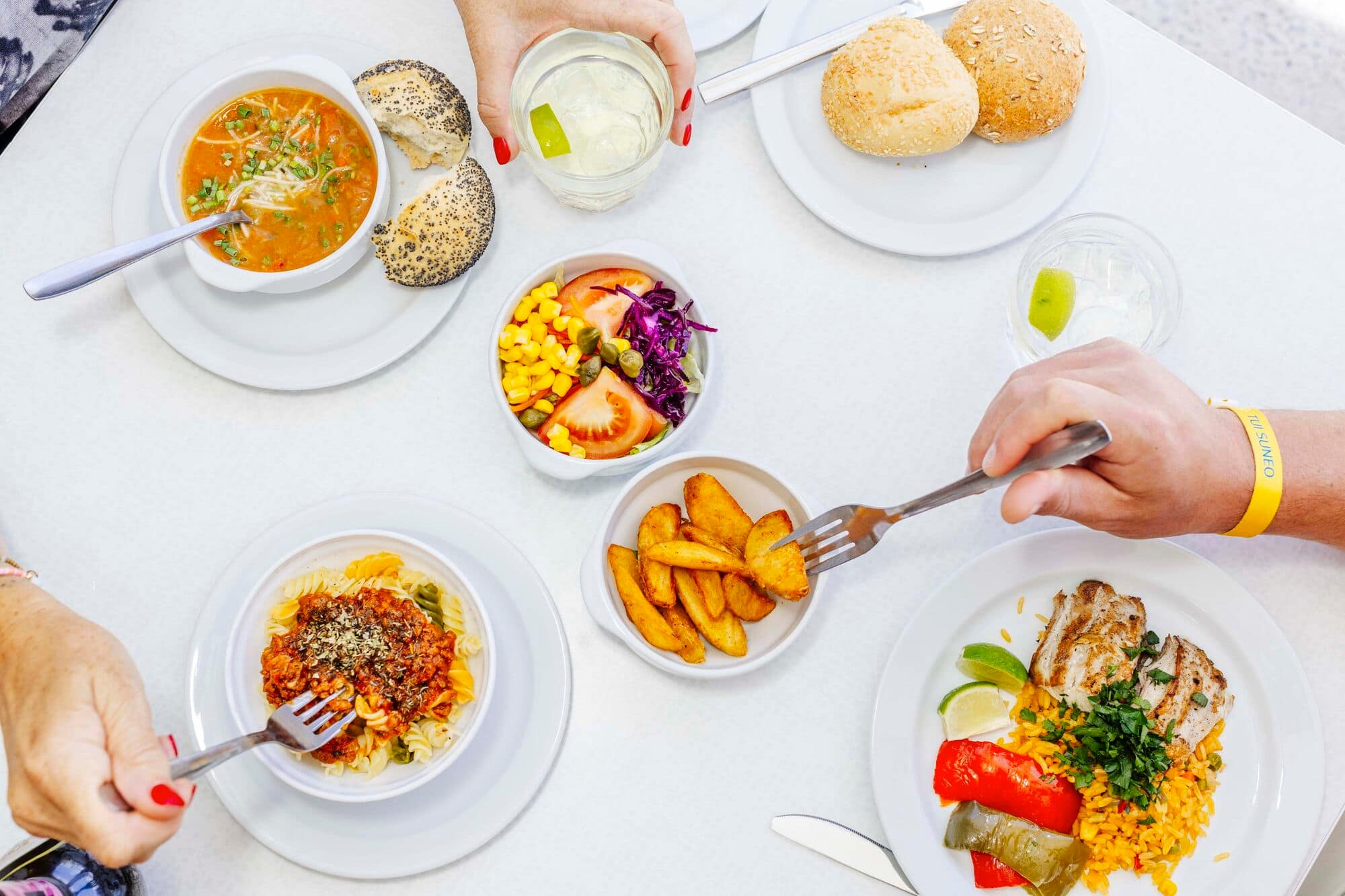 Top-down view of multiple buffet dishes on a table.