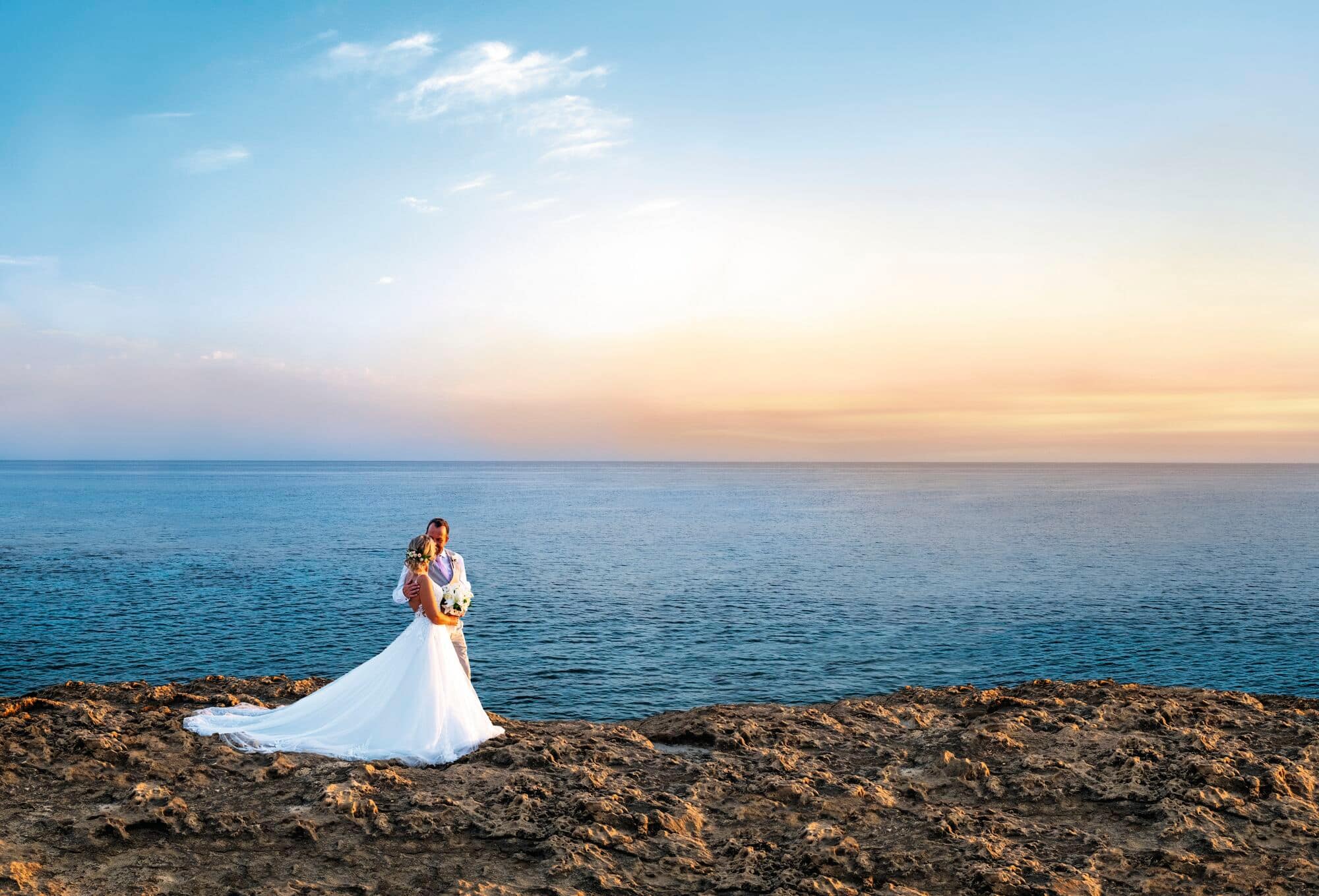 Bride & Groom walking along a beach.