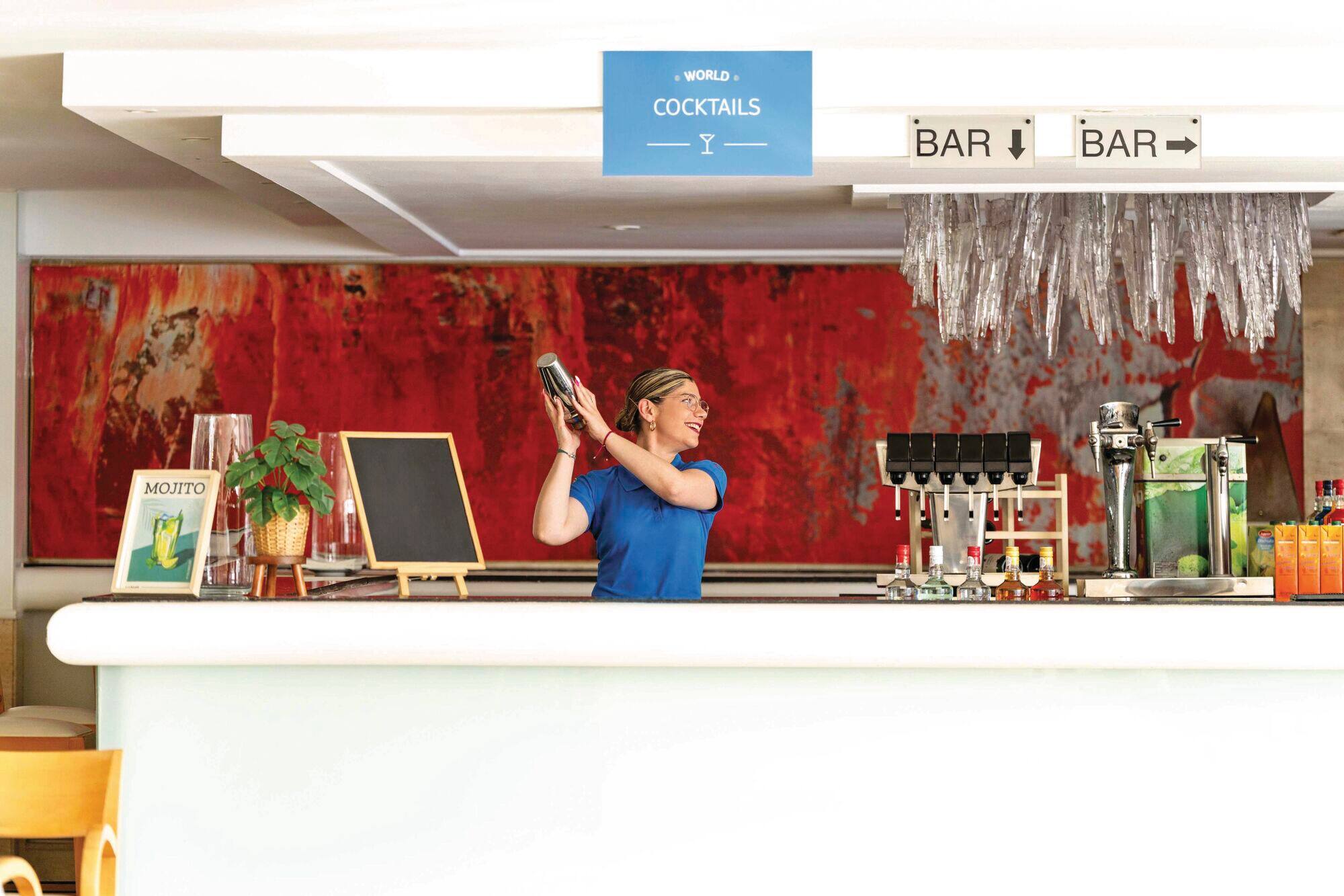 Bar tender making a cocktail.