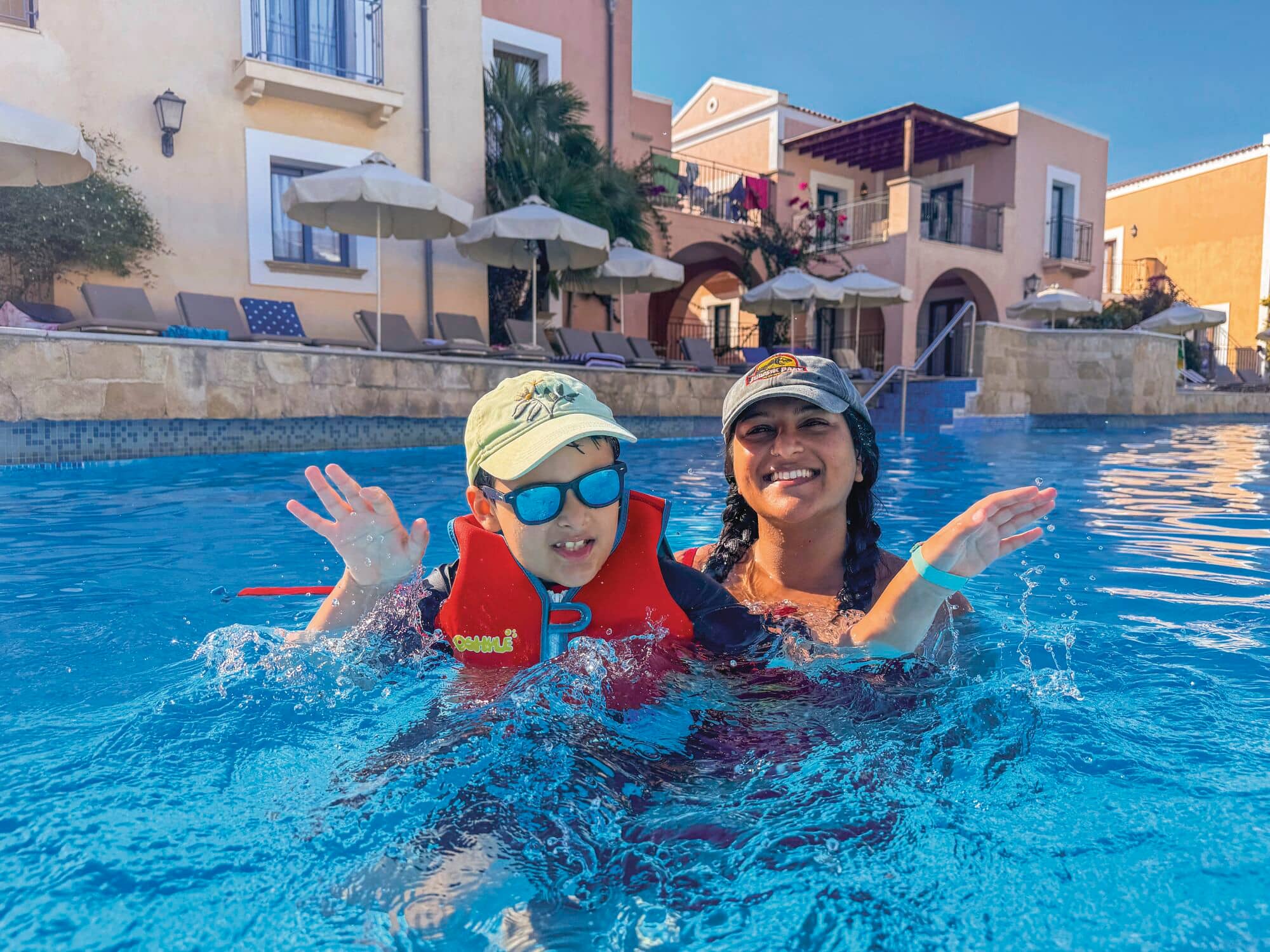 Yasmin and Remy playing in a hotel pool.