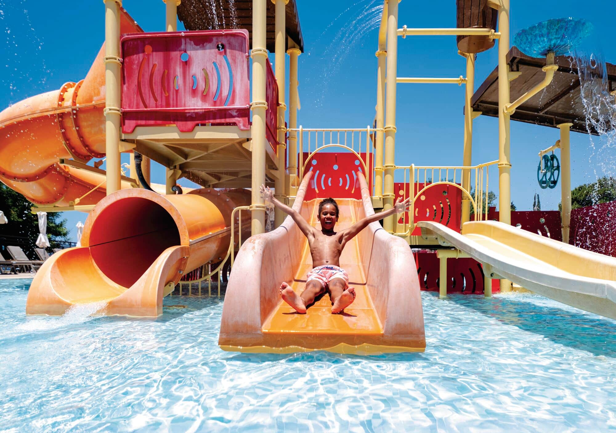 A little boy on a slide at the TUI BLUE Sensatori Atlantica Aphrodite Hills.