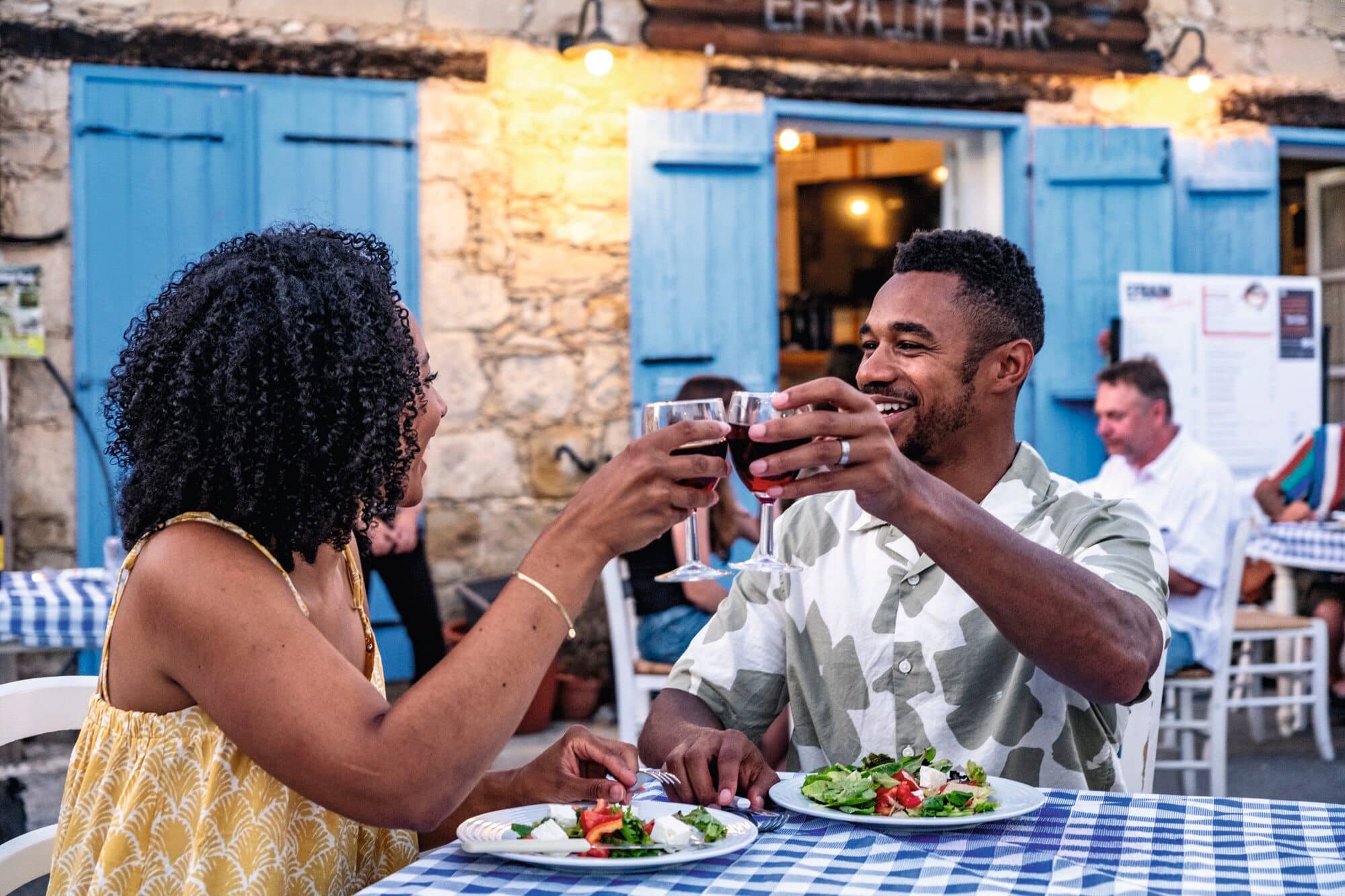 A couple enjoying a romantic dinner at a local restaurant in Kouklia, Cyprus.