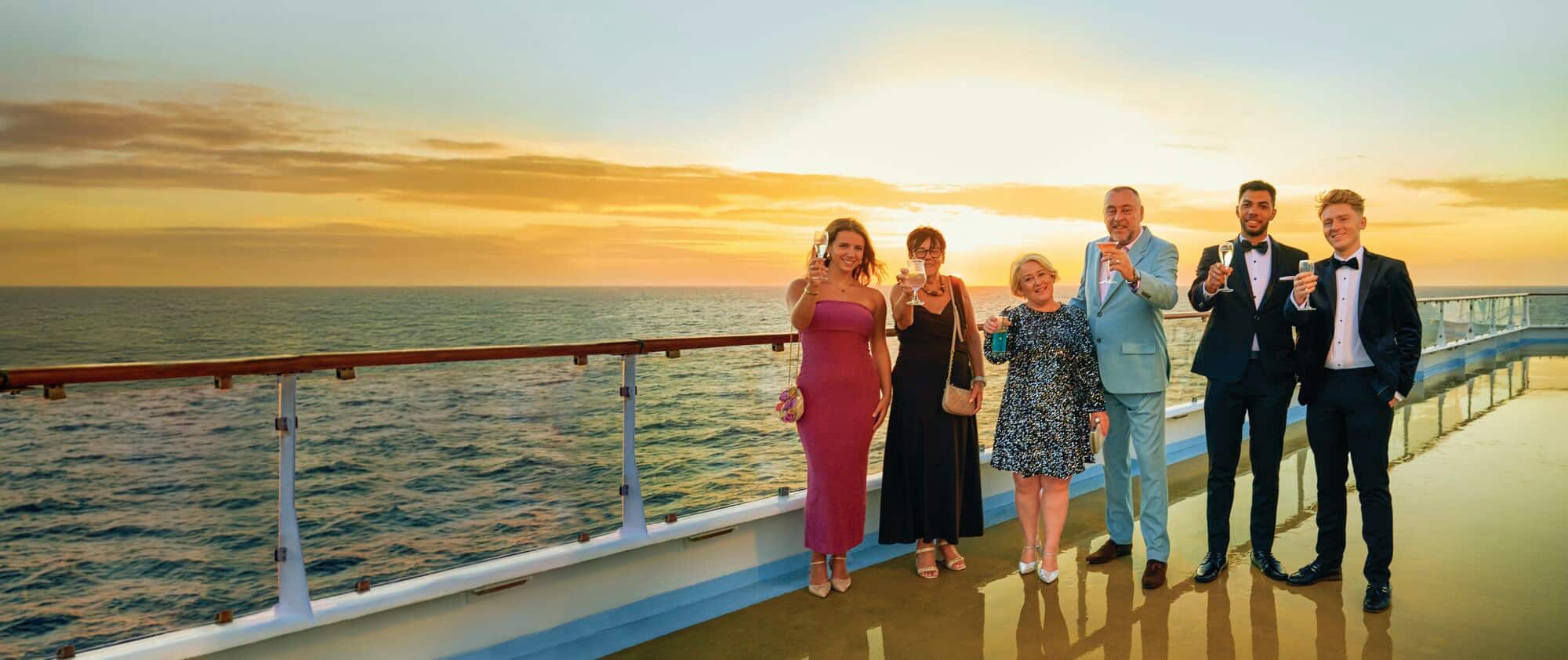 6 people in evening wear on the deck of a Marella ship.