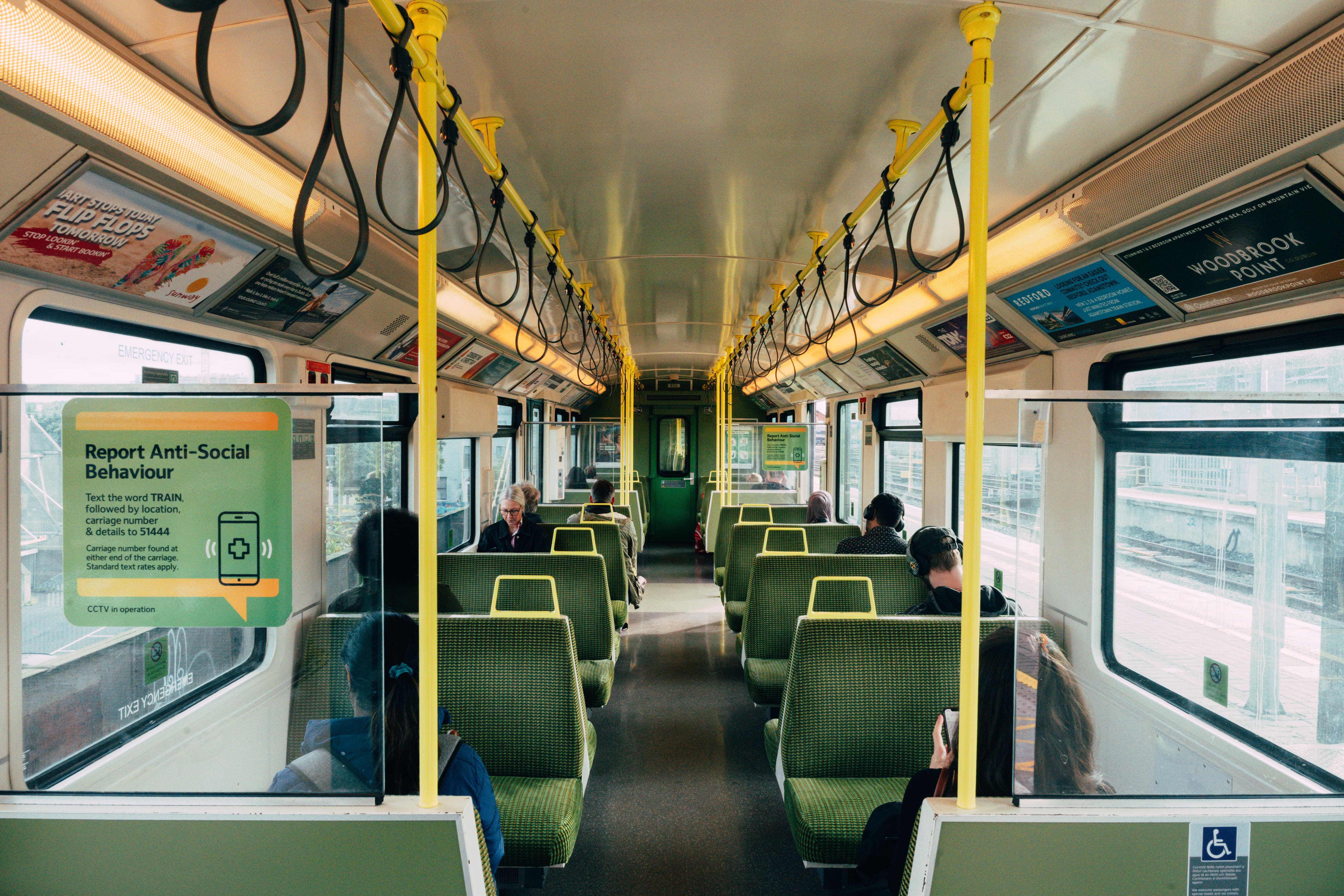 The interior of a bus with green seating.