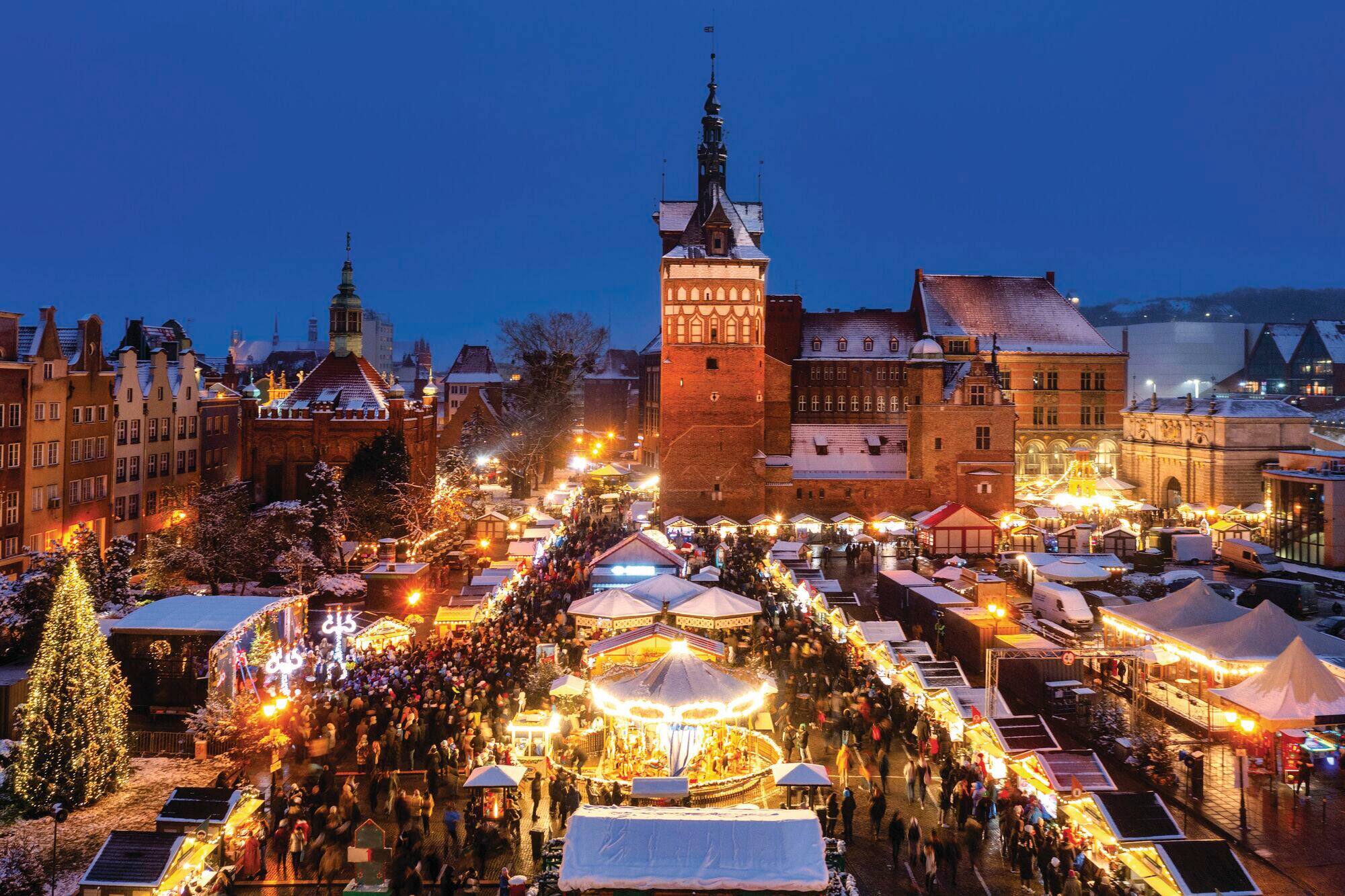 Gdansk Christmas market lit up at night.