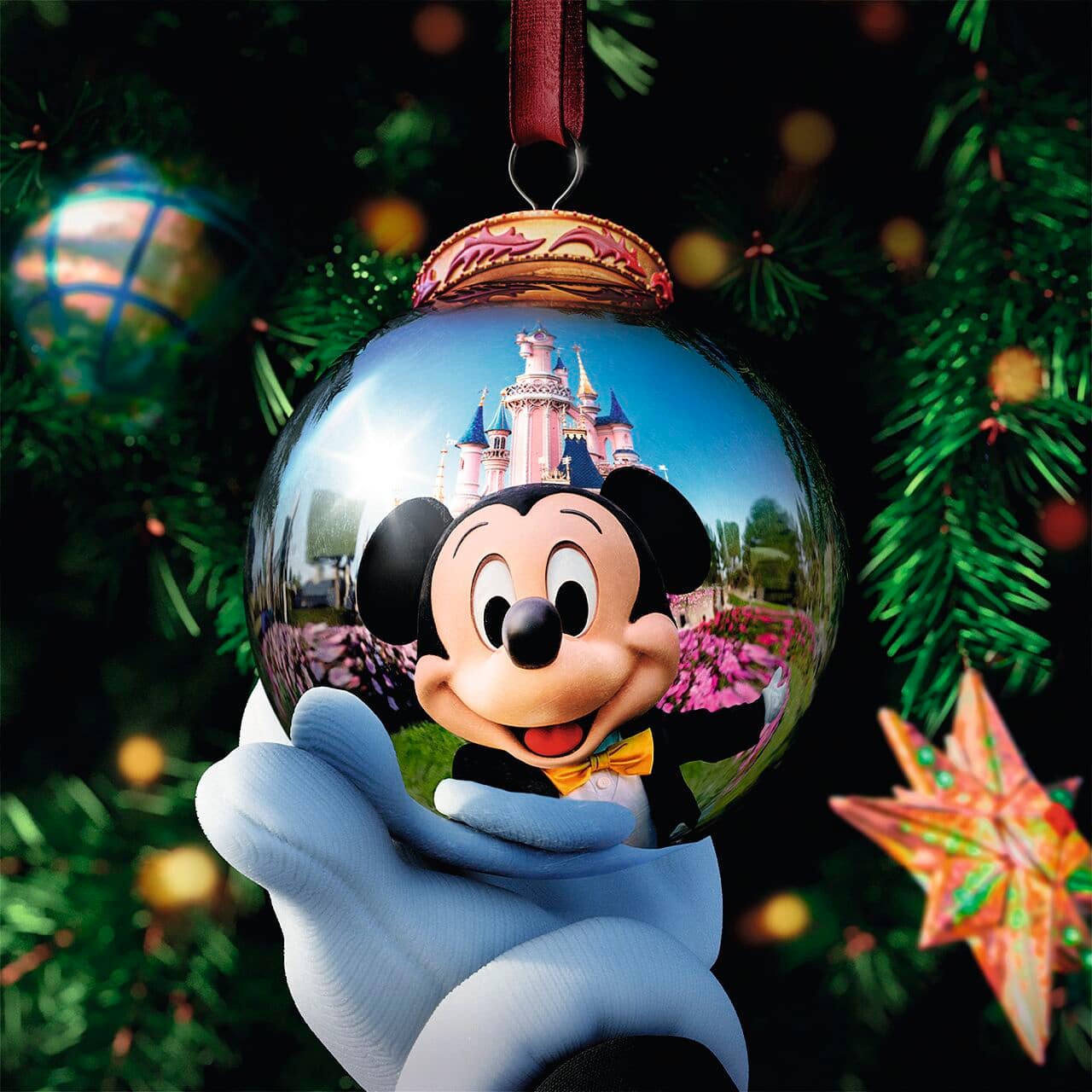 A bauble on a Christmas tree with Mickey's reflection.