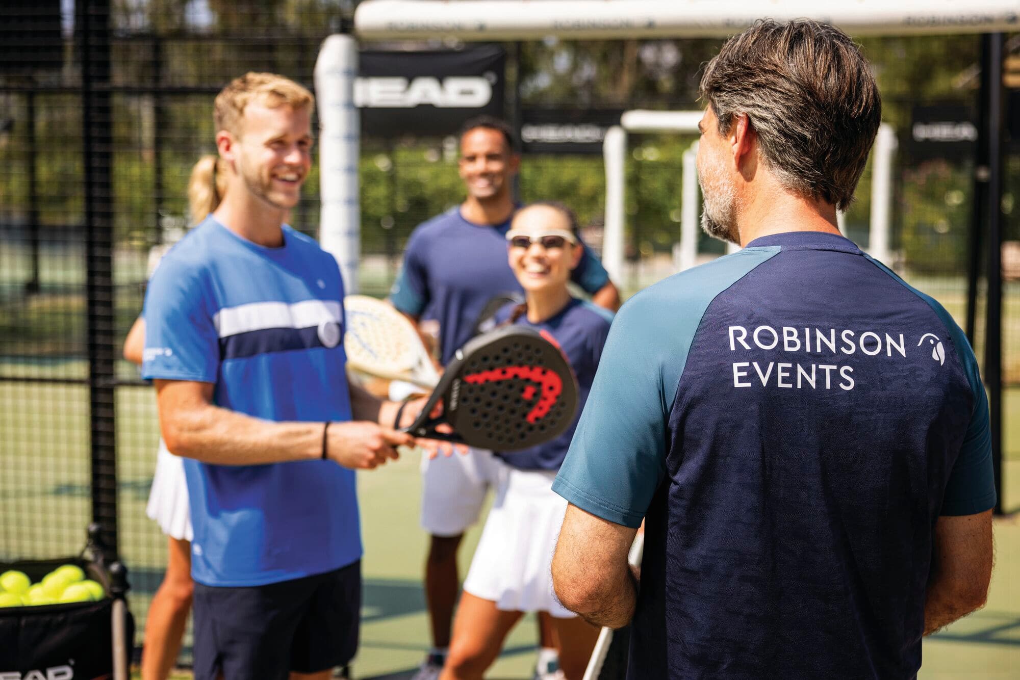 ROBINSON events staff talking to a group of people playing Padel.