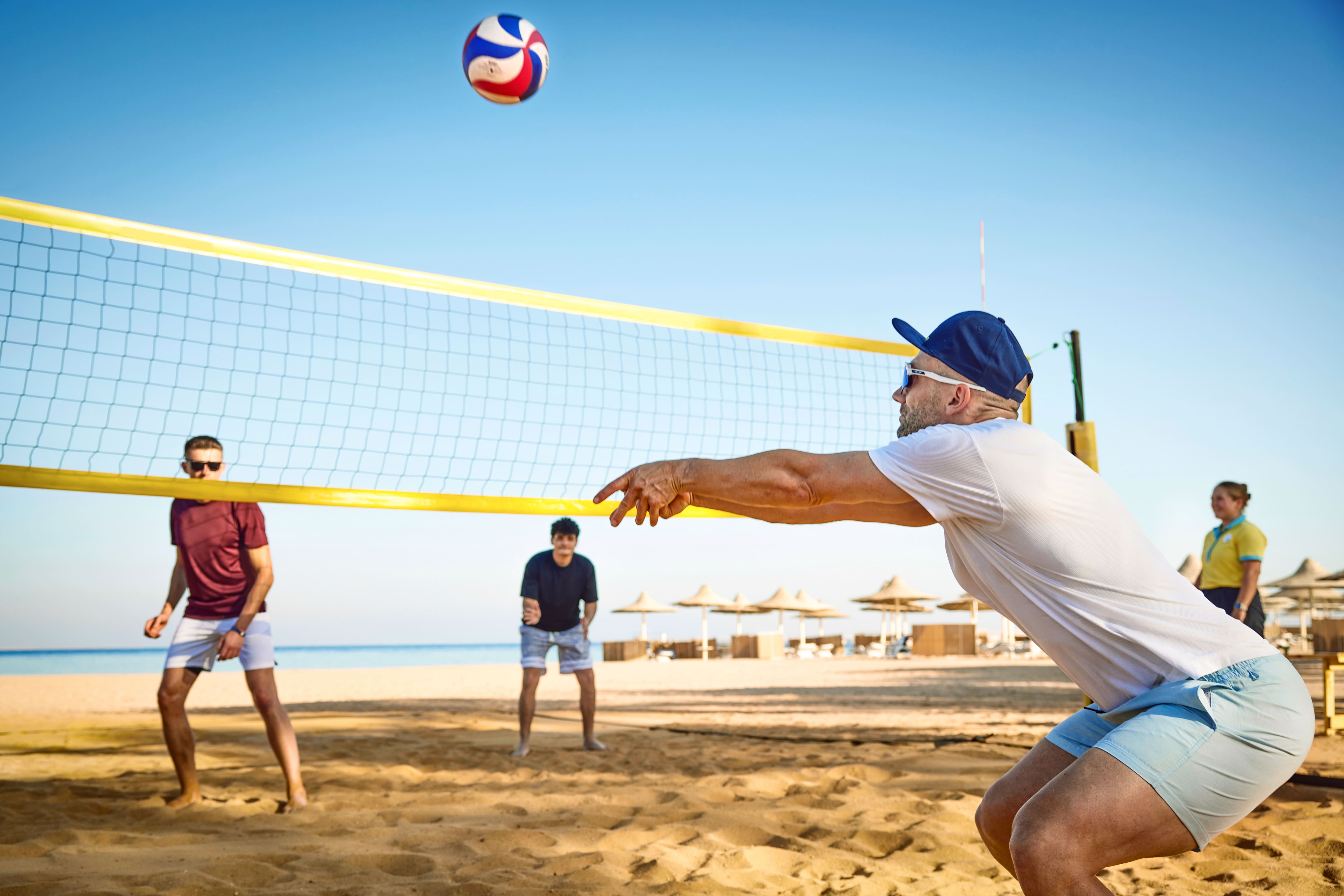 A group of people playing volleyball.