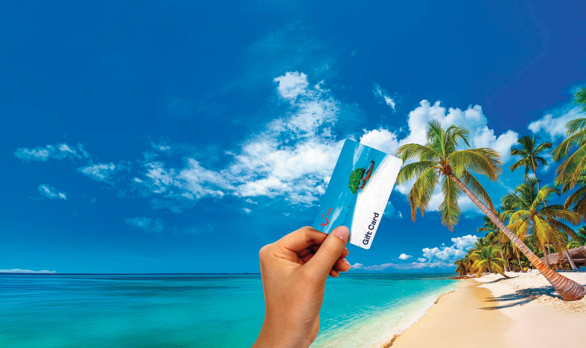 A TUI gift card on a beach.