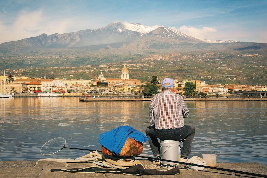 A view of the town and Mt Etna beyond from the harbour arm