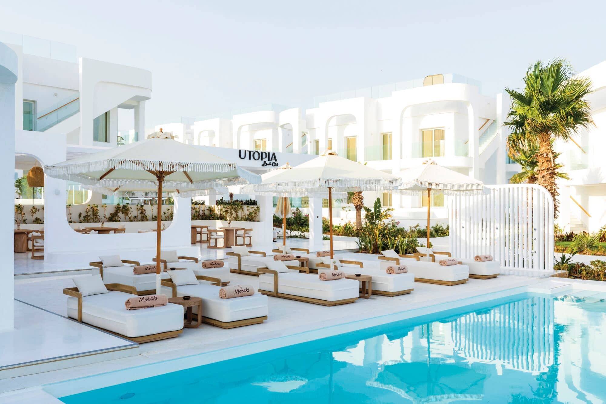 Comfy sun loungers and parasols by the pool.