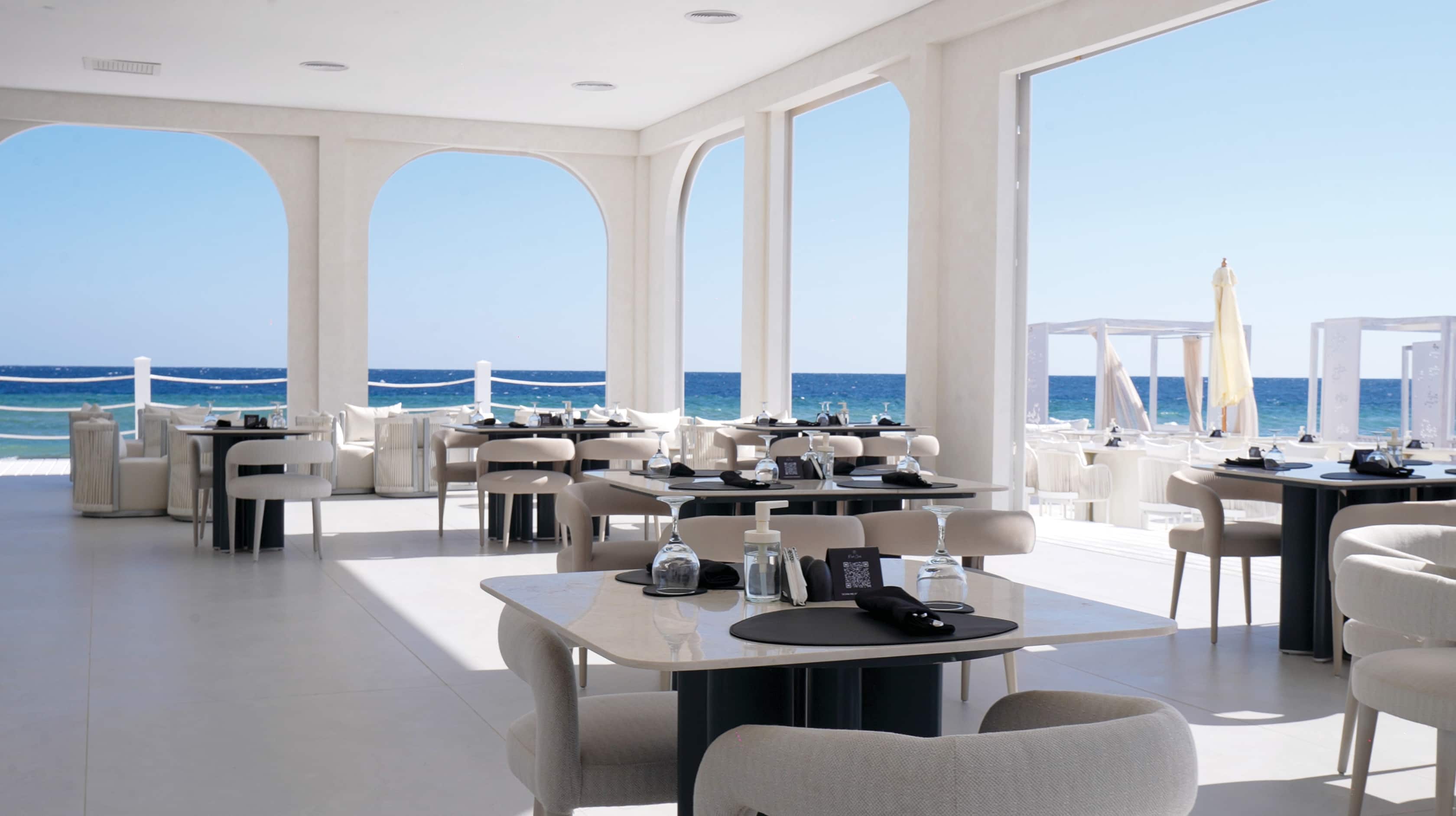 An al fresco dining area with a sea view.