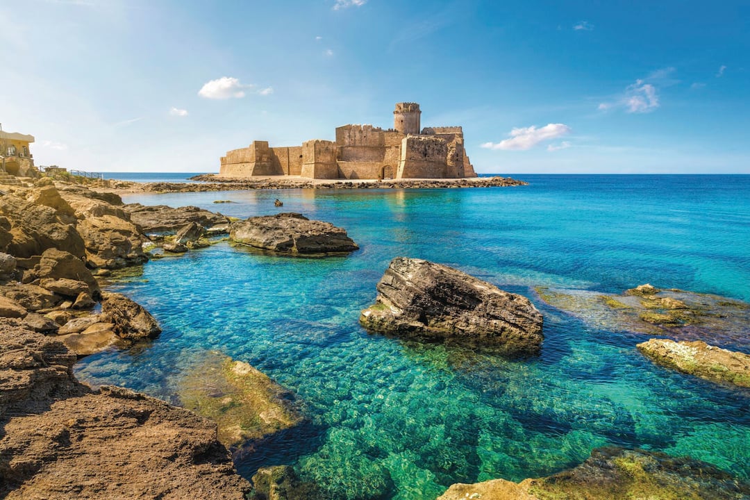 Clear blue waters with the castle beyond