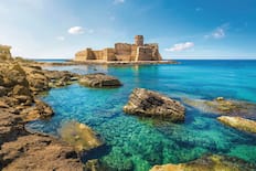 Clear blue waters with the castle beyond