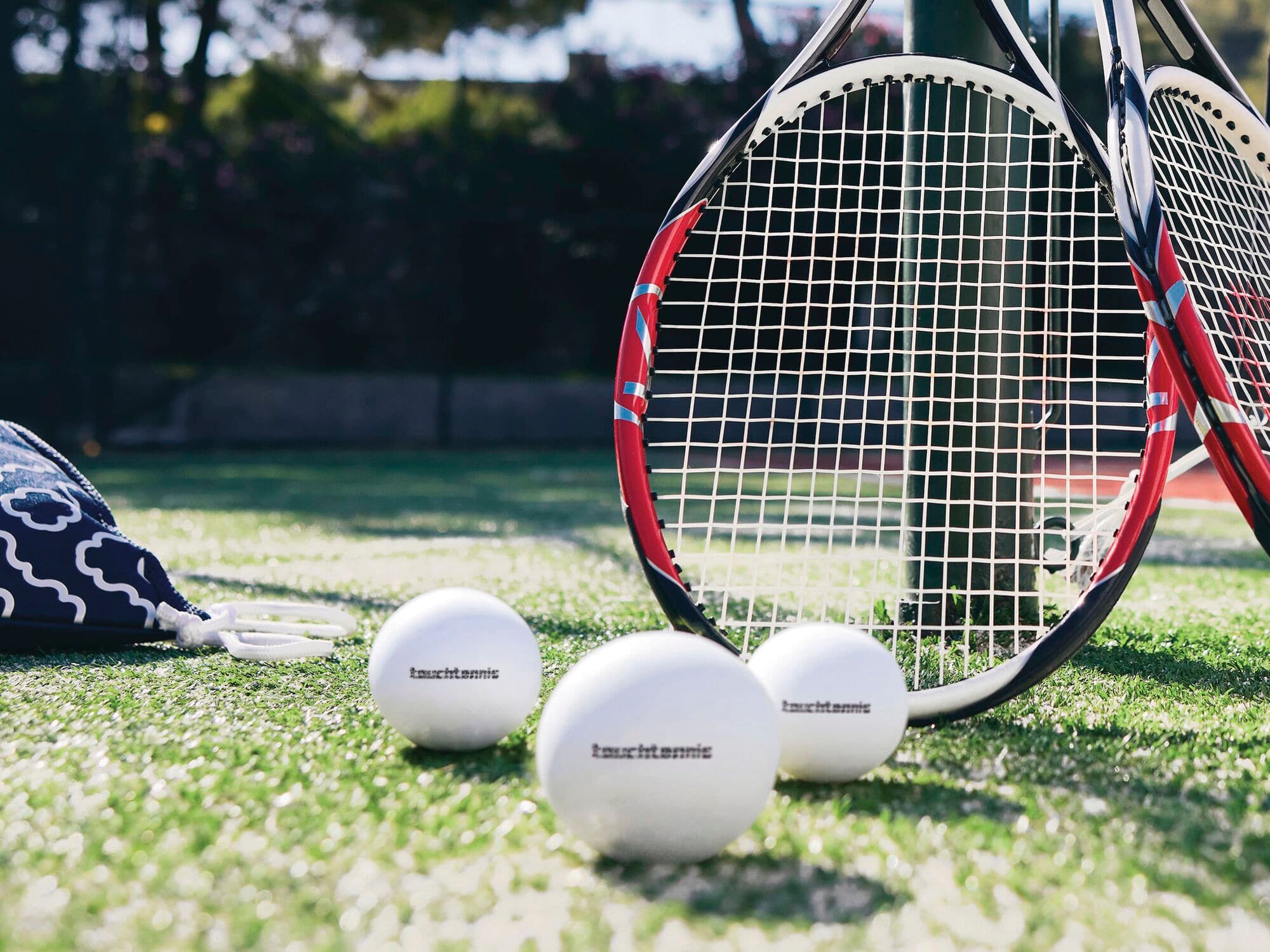 A close-up of tennis rackets and balls.