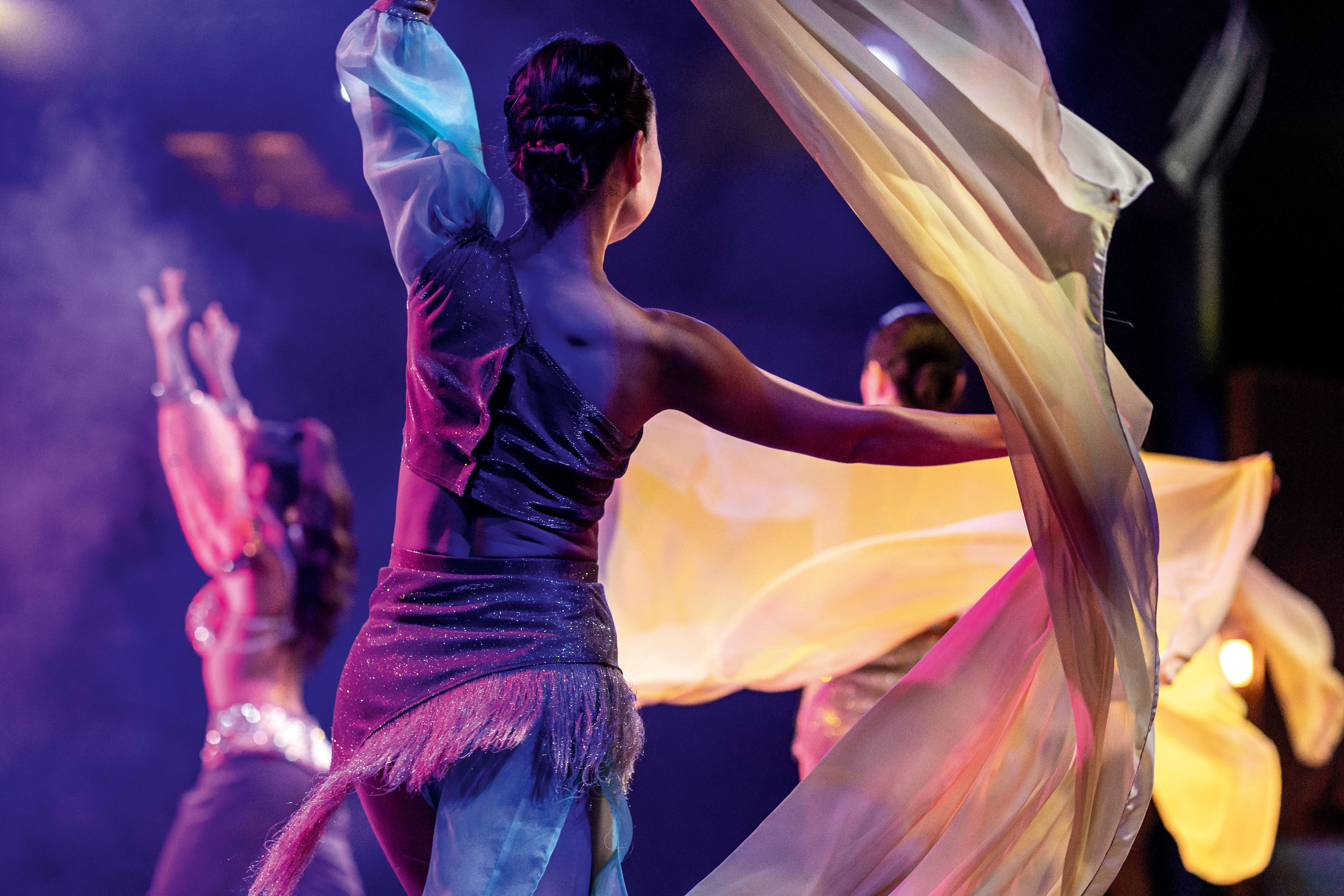 Performers dancing on stage.